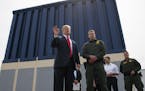 FILE - In this March 13, 2018 file photo, President Donald Trump talks with reporters as he reviews border wall prototypes in San Diego.