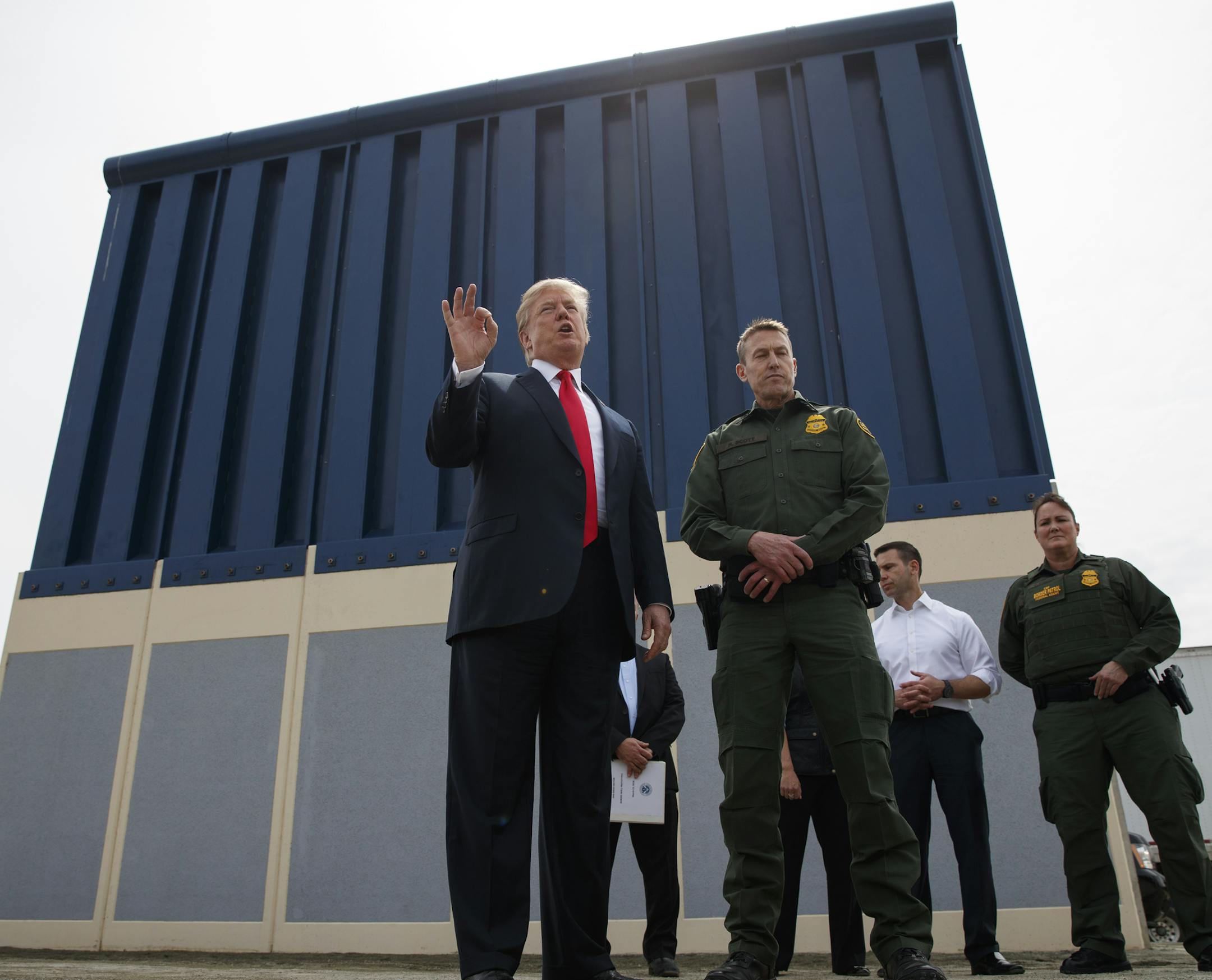 FILE - In this March 13, 2018 file photo, President Donald Trump talks with reporters as he reviews border wall prototypes in San Diego.