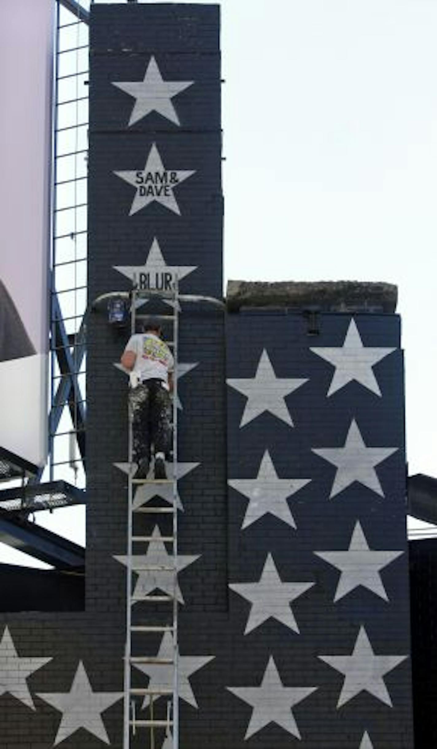 New stars on First Avenue, Berry Newman started to paint the third star of the 400 that will display names of the bands that played the historic First Avenue concert venue. ( the first painted was " Blur", the second, " Sam and Dave".