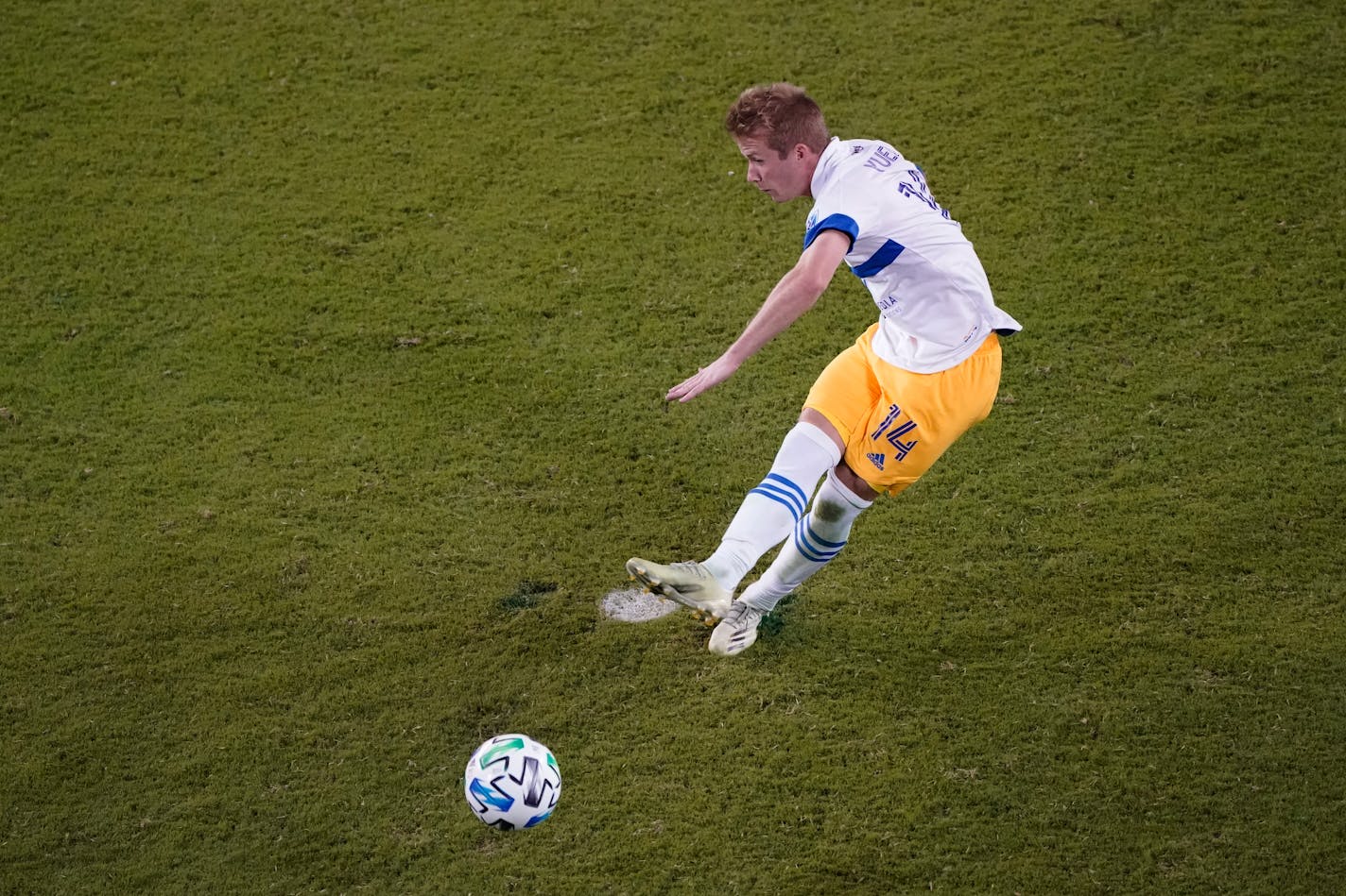 San Jose Earthquakes midfielder Jackson Yueill kicks the ball during overtime of an MLS soccer match against Sporting Kansas City Sunday, Nov. 22, 2020, in Kansas City, Kan. (AP Photo/Charlie Riedel)