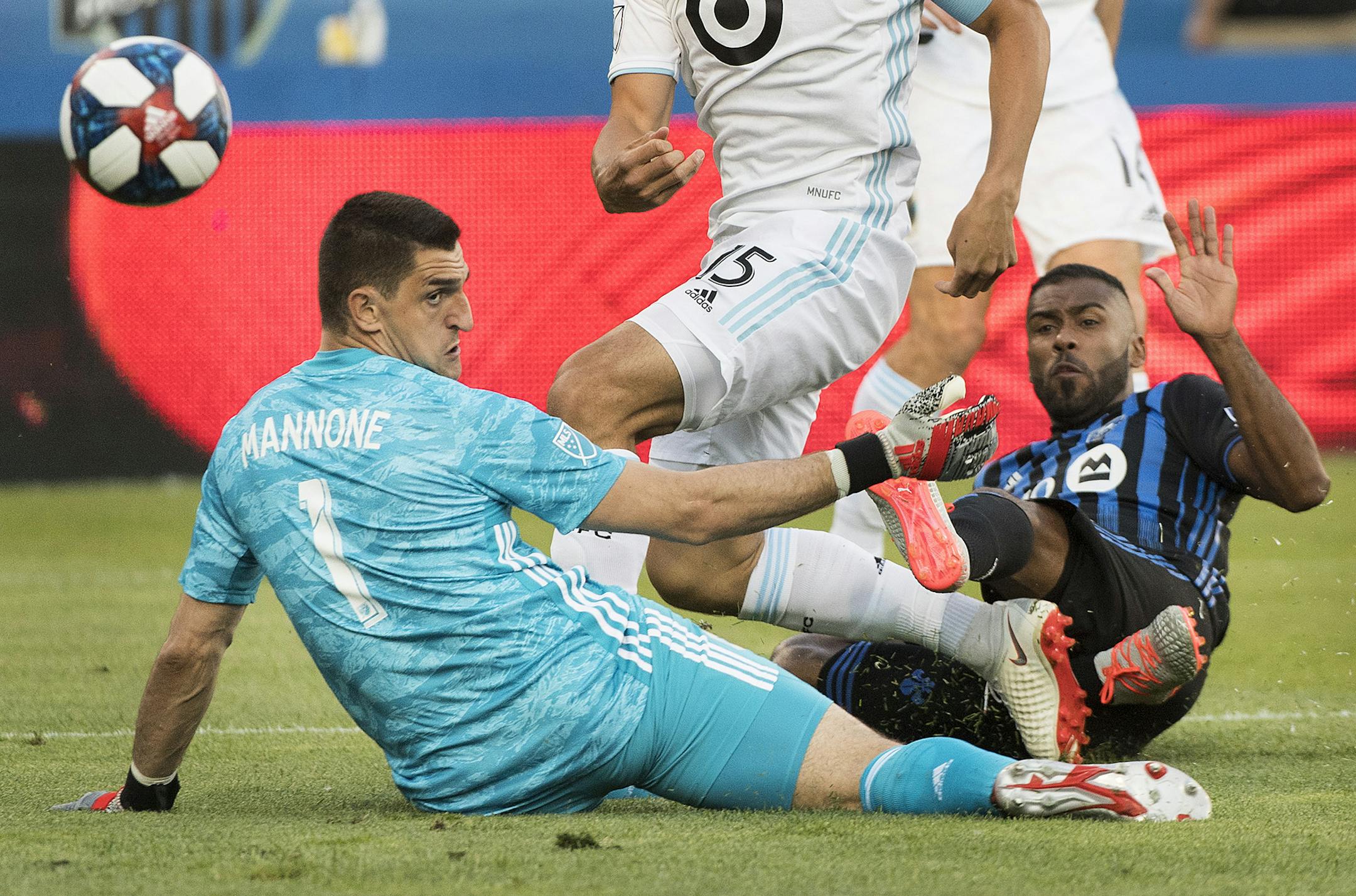 Montreal Impact's Anthony Jackson-Hamel scores against Minnesota United goalkeeper Vito Mannone during first half of an MLS soccer match in Montreal, Saturday, July 6, 2019. (Graham Hughes/The Canadian Press via AP)