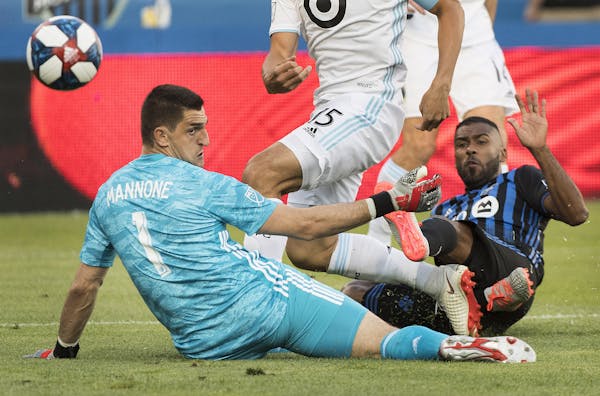 Montreal Impact's Anthony Jackson-Hamel scores against Minnesota United goalkeeper Vito Mannone during first half of an MLS soccer match in Montreal, 