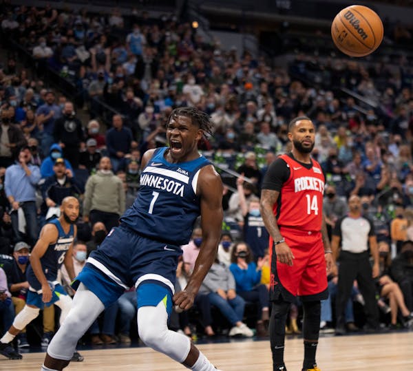 Minnesota Timberwolves guard Anthony Edwards (1) reac ted after he dunked on Houston Rockets center Alperen Sengun in the second quarter Wednesday nig