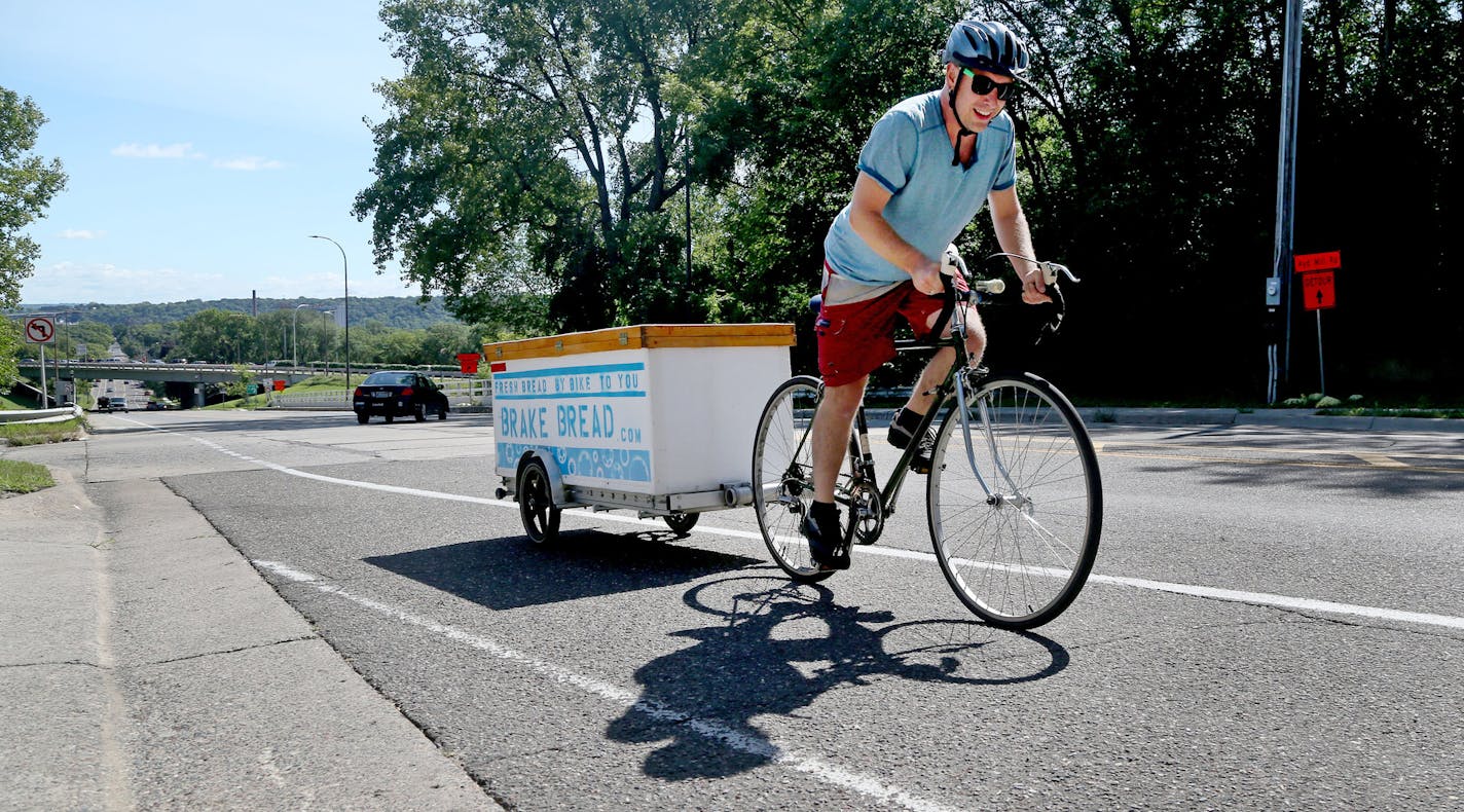 Bike delivery person Adam Patterson pedals up a big hill on Jefferson Street with a load of fresh bread from Brake Bread, an artisanal bakery that got it's start delivering bread to the area by bicycle and is now located on W. 7th near downtown and seen Thursday, Sept. 1, 2016, in St. Paul, MN.](DAVID JOLES/STARTRIBUNE)djoles@startribune Brake Bread, a new W. Seventh Street bakery, has humble beginnings: from a basket rigged to a bicycle. That's not where they baked their naturally leavened, art