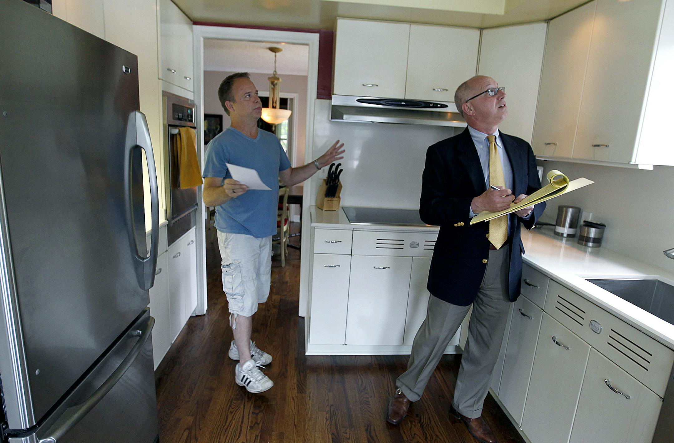 In this June 4 photo, Jim Wavra, left, who wasgetting ready to list his house, gave Century 21;s B. Patrick Ruble a tour of his home for a home analysis.