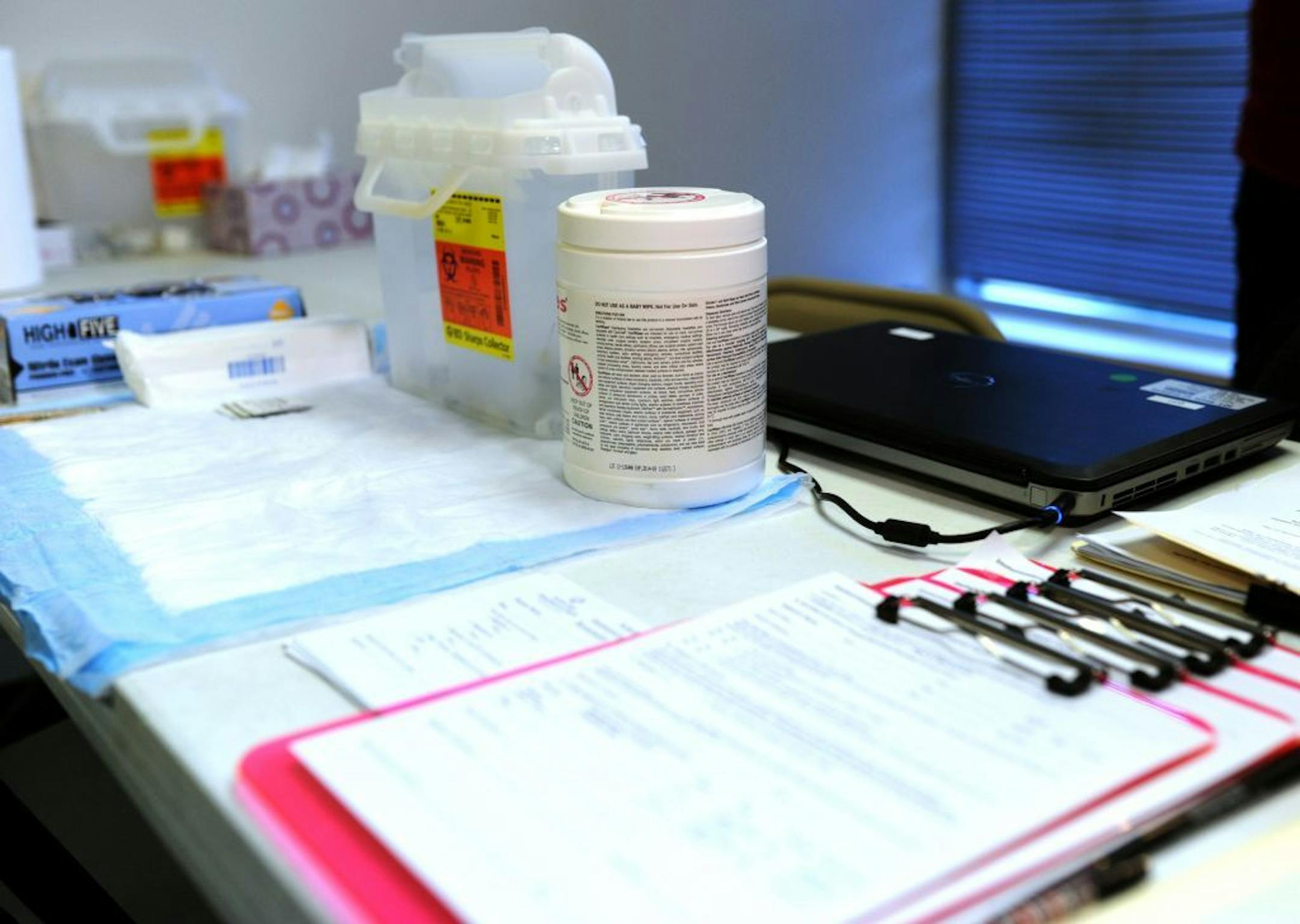 Substance abuse treatment and HIV/AIDS prevention and treatment information, with a container of clean syringes and other medical supplies are on display at a table inside the immunization office at the "one-stop shop" in Austin, Ind., Saturday, April 4, 2015. State and local health officials began a needle-exchange program Saturday where an HIV outbreak among intravenous drug users has grown to nearly 90 cases. Scott County's needle-exchange program was created through an emergency executive or