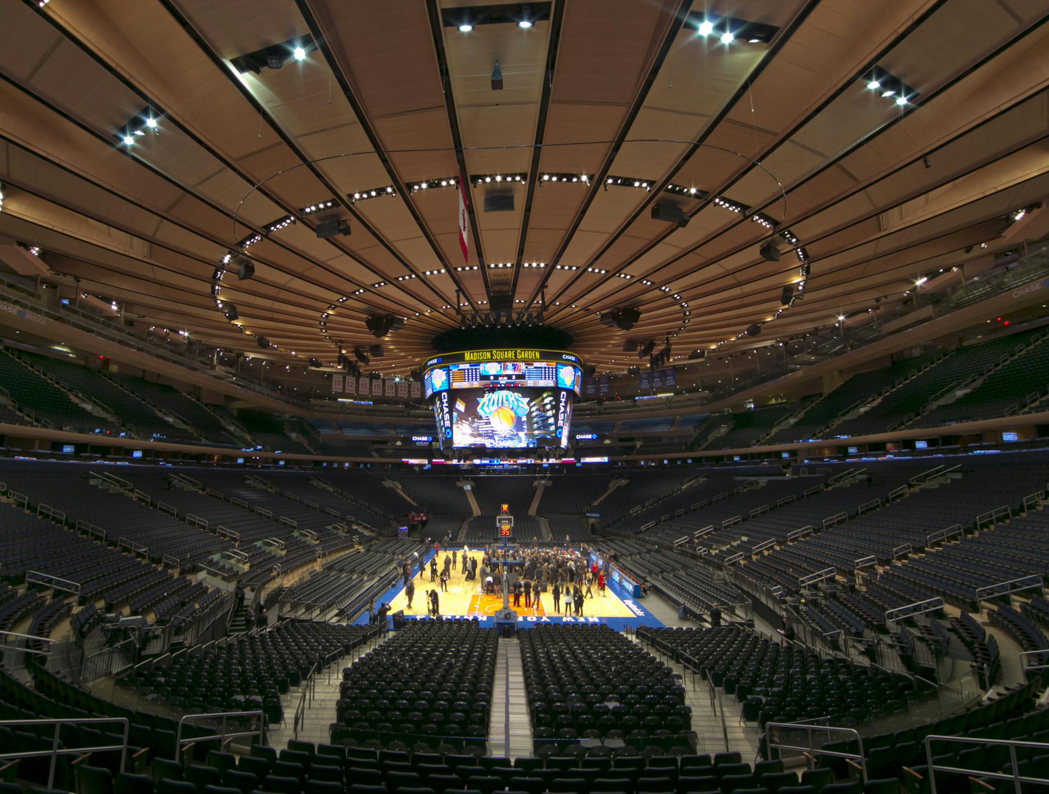 Members of the media gather on the basketball court during a tour of the newly-renovated Madison Square Garden, Thursday, Oct. 24, 2013, in New York. After three years and $1 billion, the home of the NBAís Knicks and NHLís Rangers has been remade and updated for the realities of sports in the 21st century. (AP Photo/Richard Drew) ORG XMIT: NYRD105