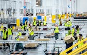 Employees at Amazon’s sorting center in Woodbury last week. Amazon opened the 525,000-square-foot building, visible from Interstate 94, in August.