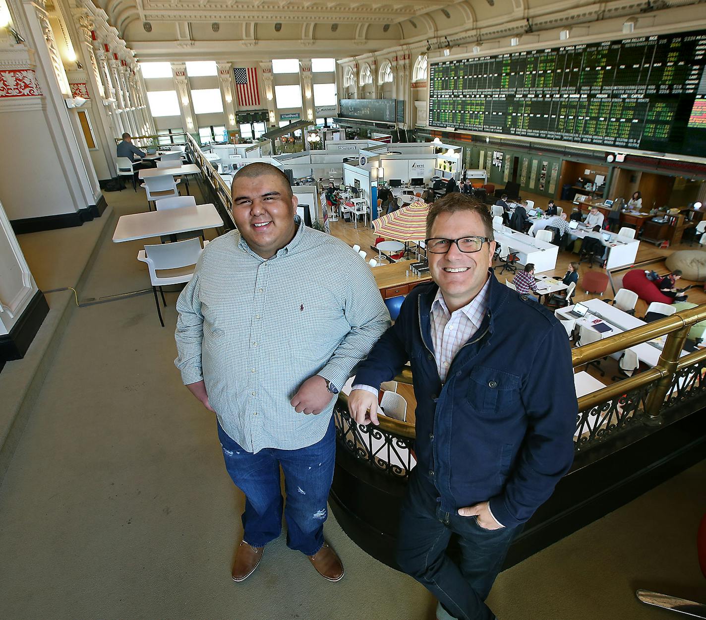 COCO CEO Kyle Coolbroth, right, and WorkMand co-founder and COCO Entrepreneur in Residence Alex Rodriguez, left, at COCO, located in the old Grain Exchange trading floor in the Grain Exchange Building. The collaborative workspace that has been home to hundreds of startup businesses, has launched fellowships for minority entrepreneurs.