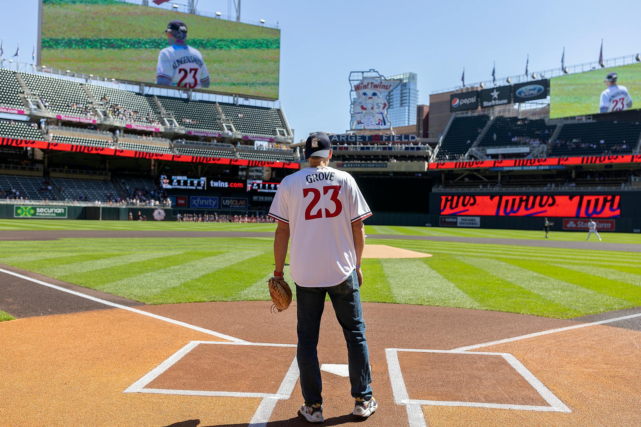 Incoming Star Tribune publisher Steve Grove stood behind home plate ready to catch the ceremonial first pitch thrown by retiring Star Tribune publisher Mike Klingensmith.