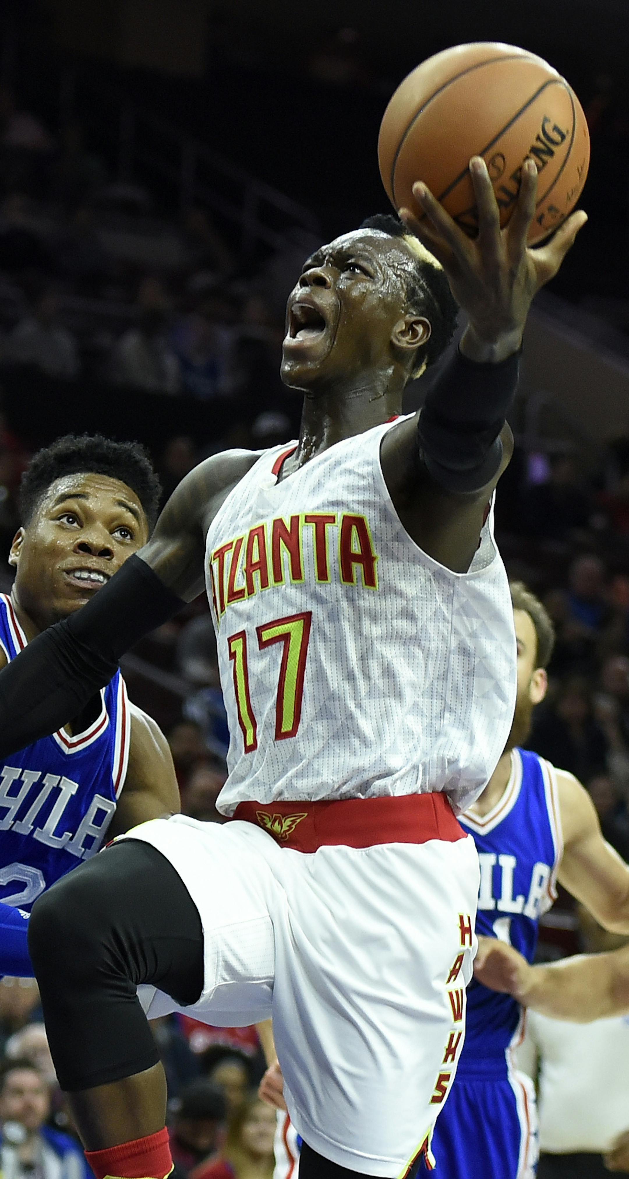 Atlanta Hawks' Dennis Schroder (17) drives to the basket past Philadelphia 76ers' Richaun Holmes (22) during the first half of an NBA basketball game, Saturday, Oct. 29, 2016, in Philadelphia. (AP Photo/Michael Perez)