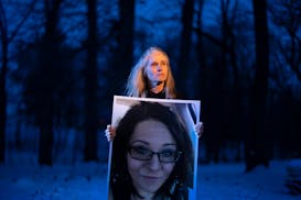 Tracy Dettling, holding a photo of her late daughter Heather Mayer, stands in the frozen remains of a garden Heather planted for her years ago at home