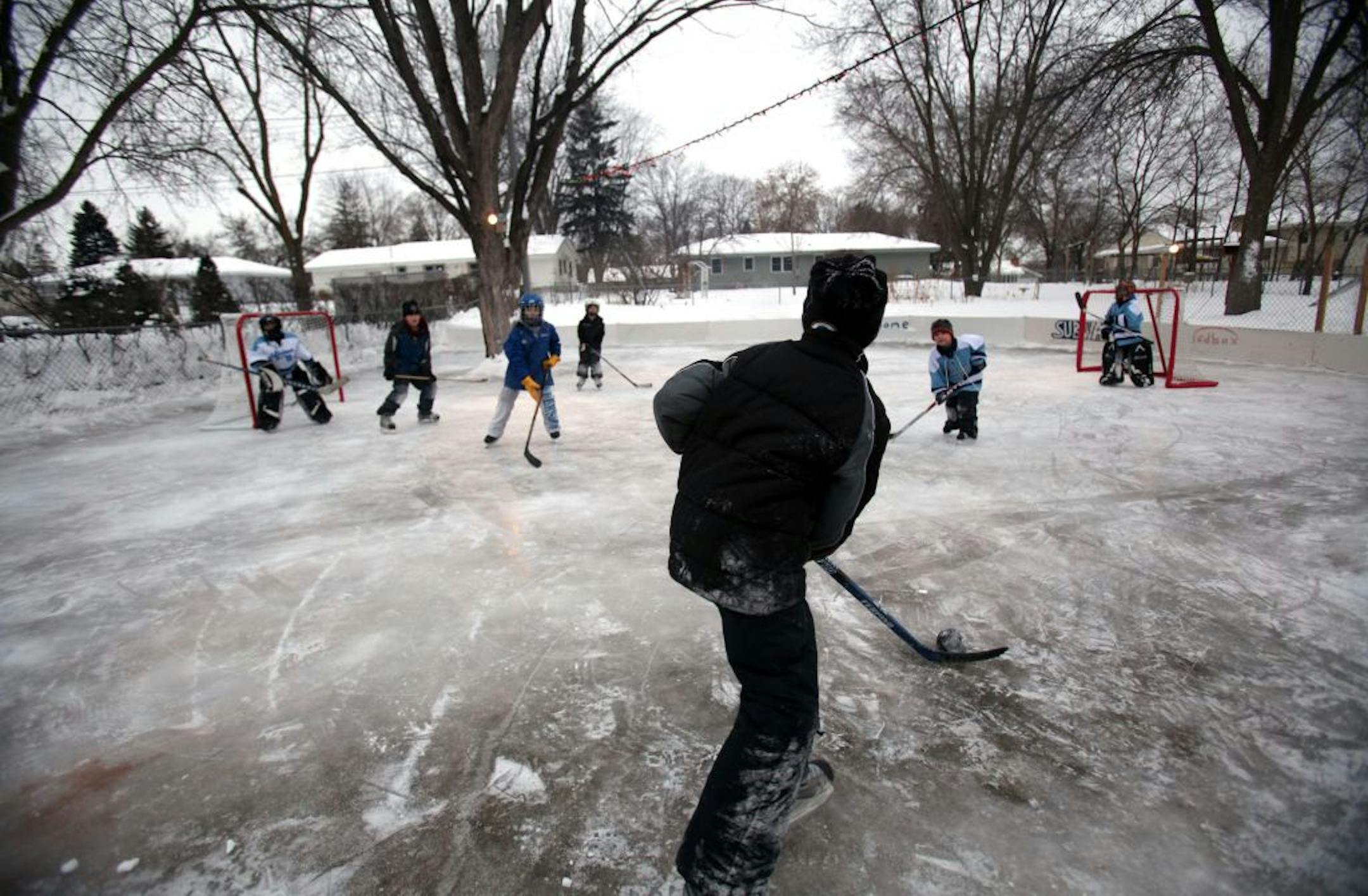 Tyler Noble, 9, headed back onto the ice with friends waiting to collect the puck as they played at his backyard ice rink.