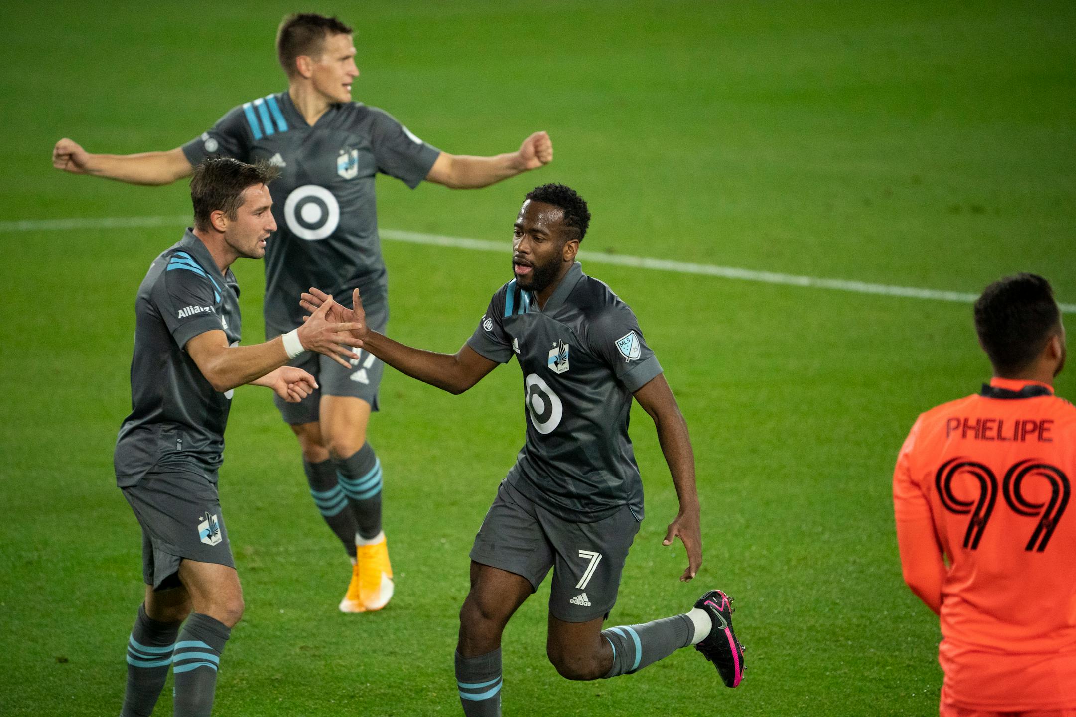 Minnesota United midfielder Kevin Molino (7) celebrated his first half goal with teammate midfielder Ethan Finlay (13) and midfielder Robin Lod (17)