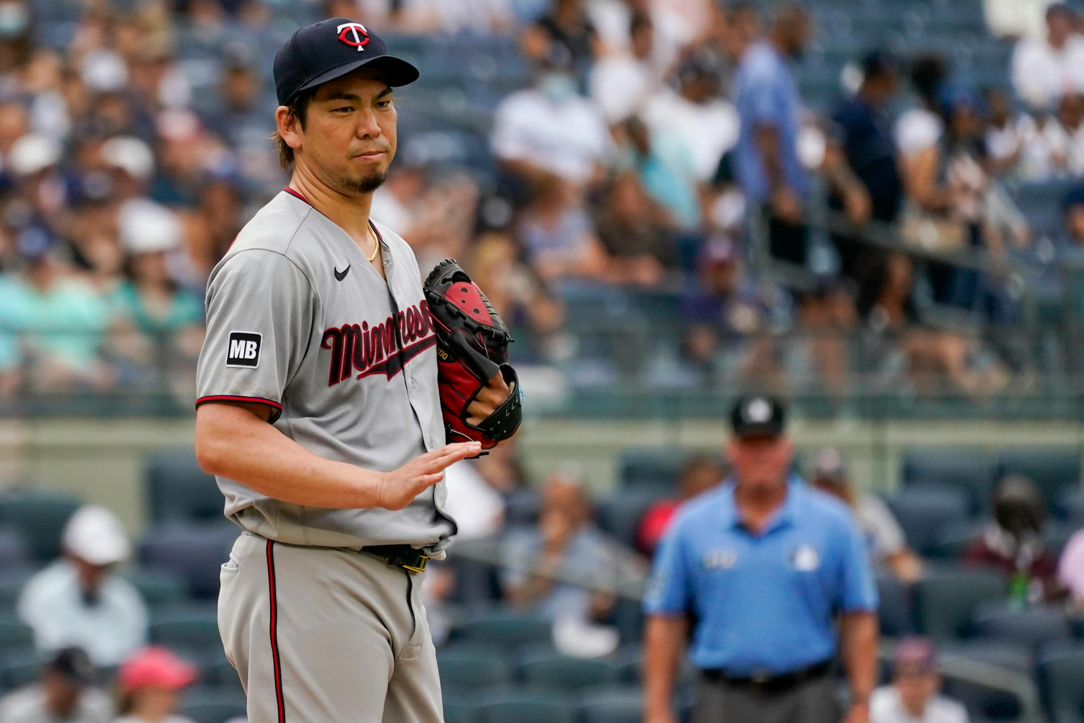 Minnesota Twins pitcher Kenta Maeda gestures to Rougned Odor after hitting him with a pitch in the second inning of a baseball game, Saturday, Aug. 21, 2021, in New York. (AP Photo/Mary Altaffer)