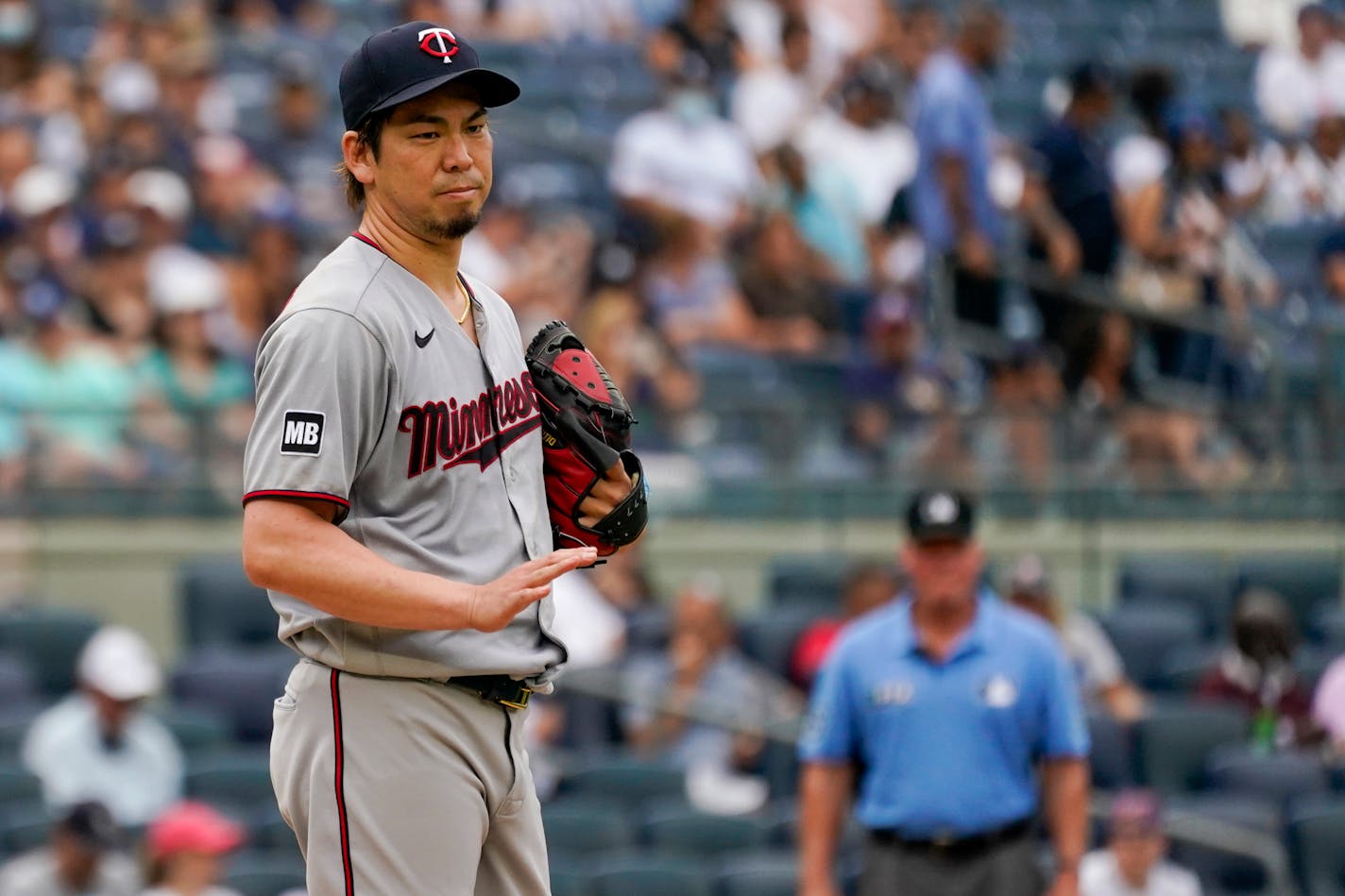 Minnesota Twins pitcher Kenta Maeda gestures to Rougned Odor after hitting him with a pitch in the second inning of a baseball game, Saturday, Aug. 21, 2021, in New York. (AP Photo/Mary Altaffer)