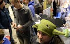 Paul Williams wears a Yoda beanie while waiting in line during opening night of "Star Wars: The Force Awakens" at Century Theatre in Boulder, Colo., T