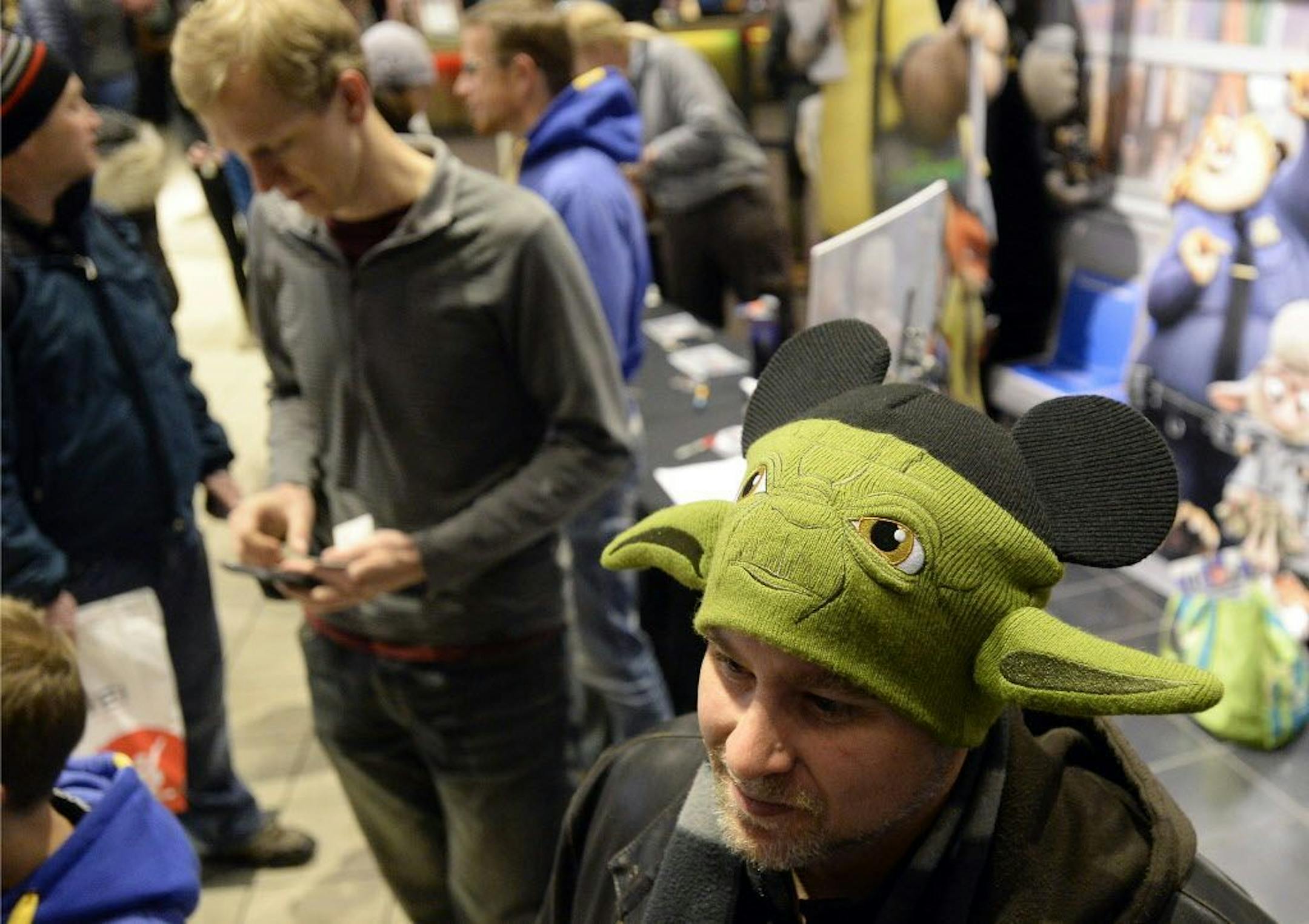 Paul Williams wears a Yoda beanie while waiting in line during opening night of "Star Wars: The Force Awakens" at Century Theatre in Boulder, Colo., Thursday, Dec. 17, 2015.