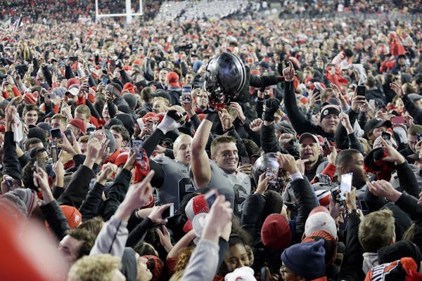 Ohio State Buckeyes defensive end Sam Hubbard (6) walks off as fans rush the field following a 39-38 win against Penn State on Saturday, Oct. 28, 2017