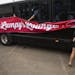 A group of Tim Herron fans raise a "Lumpy's lounge" sign on their bus that comes out to PGA tour events occasionally to support Herron. ALEX KORMANN &