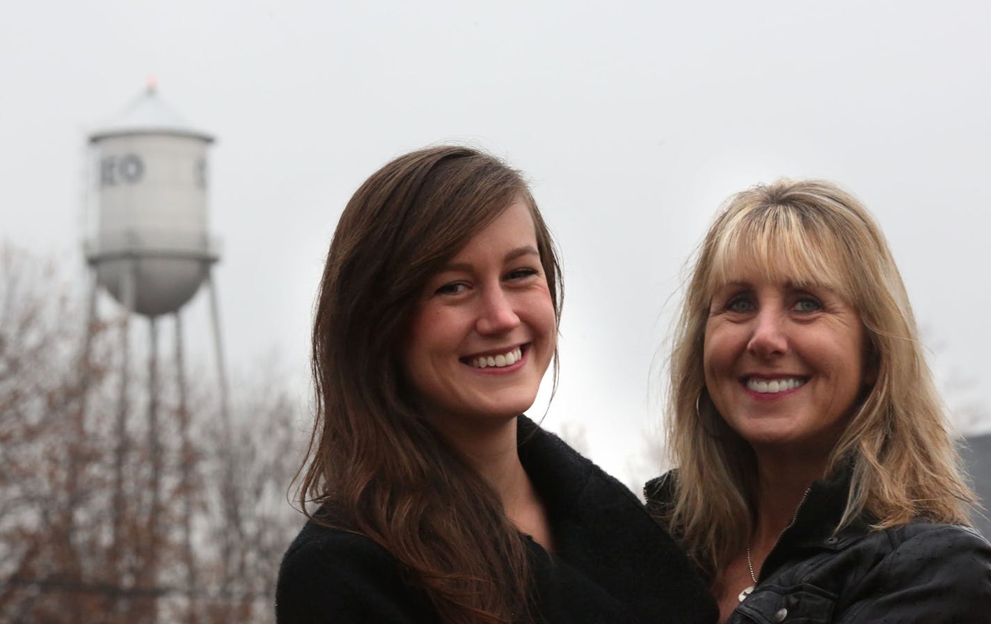 Kathleen Gette, right, and her daughter Lauren Bowe, 24, stood near the old water tower in Osseo. ] (KYNDELL HARKNESS/STAR TRIBUNE) kyndell.harkness@startribune.com In Osseo, Min., Wednesday, November 5, 2014. With the help of her daughter Lauren resident Kathleen Gette is leading the effort to save the iconic structure and add it to the list of 11 Minnesota water towers on the National Historic Registry.