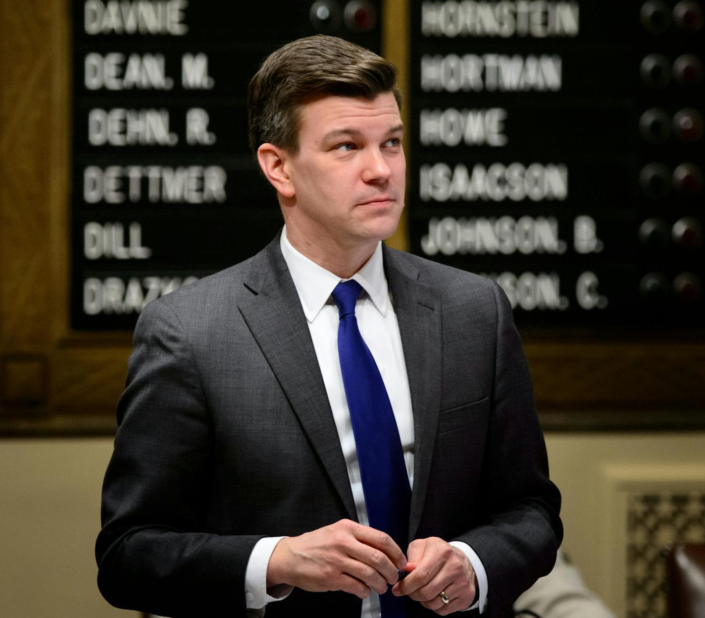 In a Thursday, Feb. 19, 2015 photo, Rep. Ryan Winkler stands on the House floor., in St. Paul, Minn. Winkler said said Thursday, May 21, 2015 that he will give up his seat in the state House as his family moves to Brussels. His seat in comfortably Democratic territory will be subject to a special election, and the outcome won't alter the House Republican control for the next year. (Glen Stubbe/Star Tribune via AP) MANDATORY CREDIT; ST. PAUL PIONEER PRESS OUT; MAGS OUT; TWIN CITIES LOCAL TELEVISI