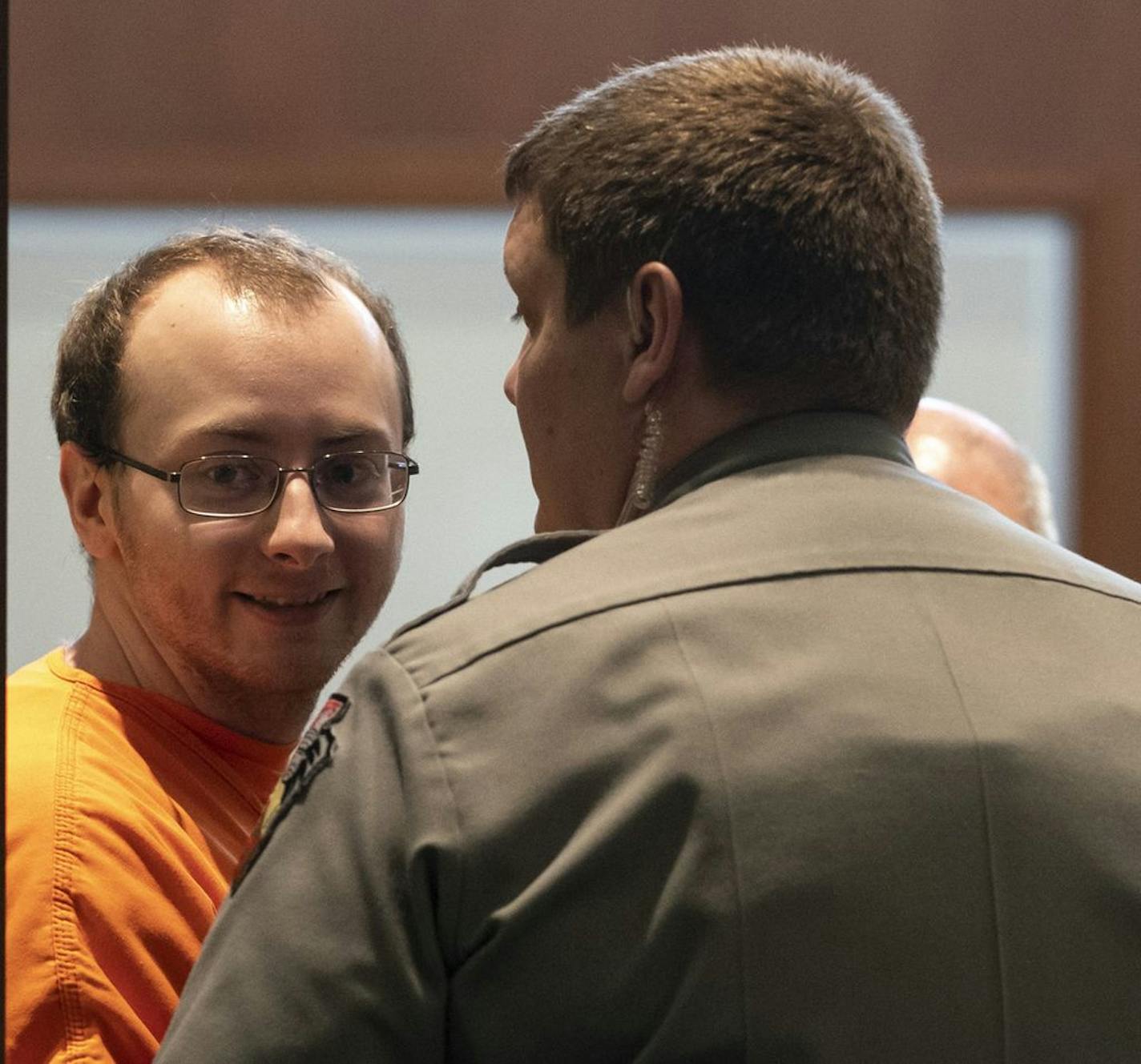 Jake Patterson, accused of abducting 13-year-old Jayme Closs after murdering her parents and holding her captive for three months in a northern Wisconsin cabin, looked toward his father in the gallery as he arrived in court during a hearing where he plead guilty at the Barron County Justice Center in Barron, Wis., on Wednesday.