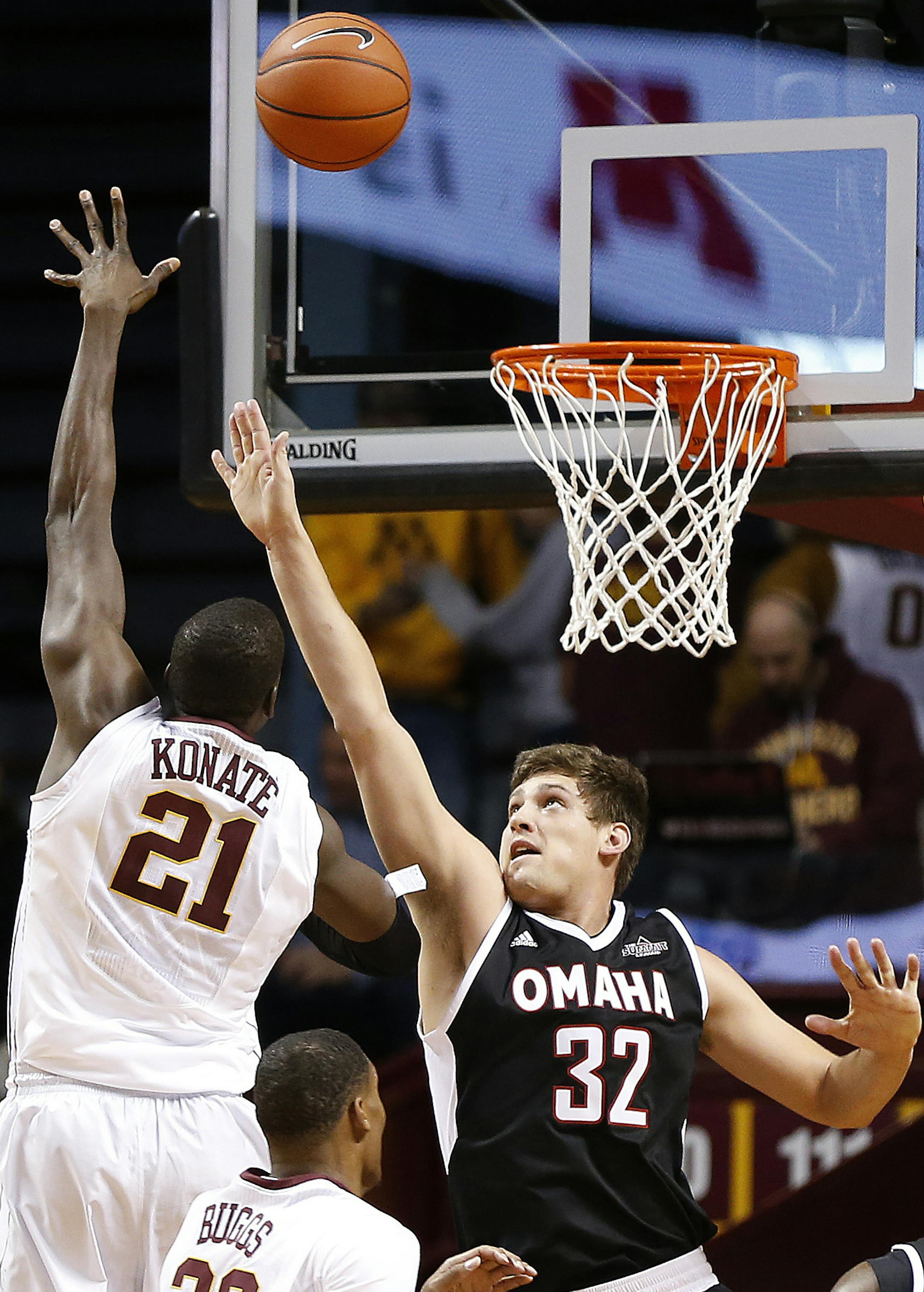 Minnesota center Bakary Konate (21) shoots the ball against Nebraska-Omaha forward Daniel Meyer (32) in the first half of an NCAA college basketball game Friday, Nov. 27, 2015 at Williams Arena in Minneapolis. (AP Photo/Stacy Bengs)