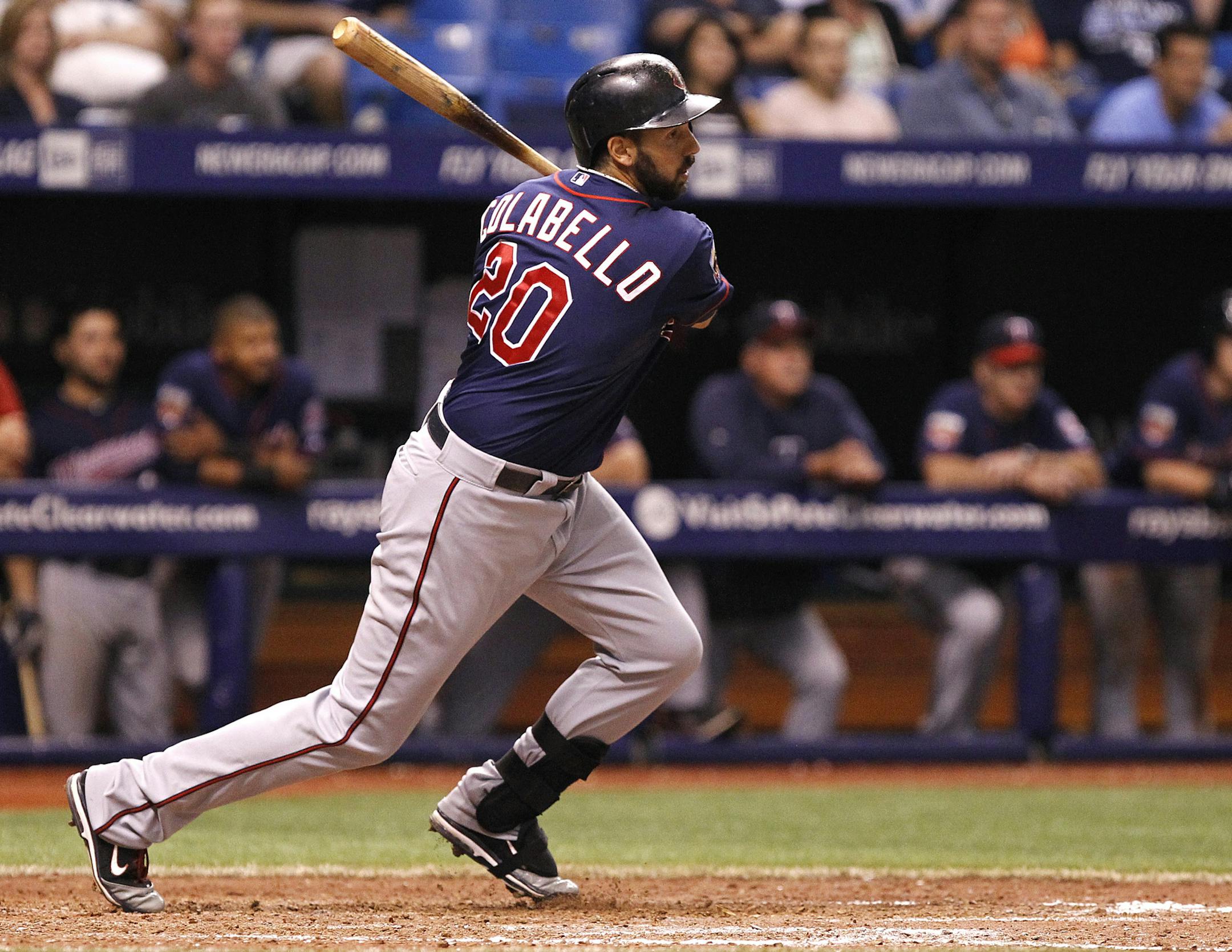 Minnesota Twins' Chris Colabello follows through on his two-run single to score teammates Joe Mauer and Trevor Plouffe during the top of the 12th inning of a baseball game against the Tampa Bay Rays Wednesday, April 23, 2014, in St. Petersburg, Fla. (AP Photo/Brian Blanco)