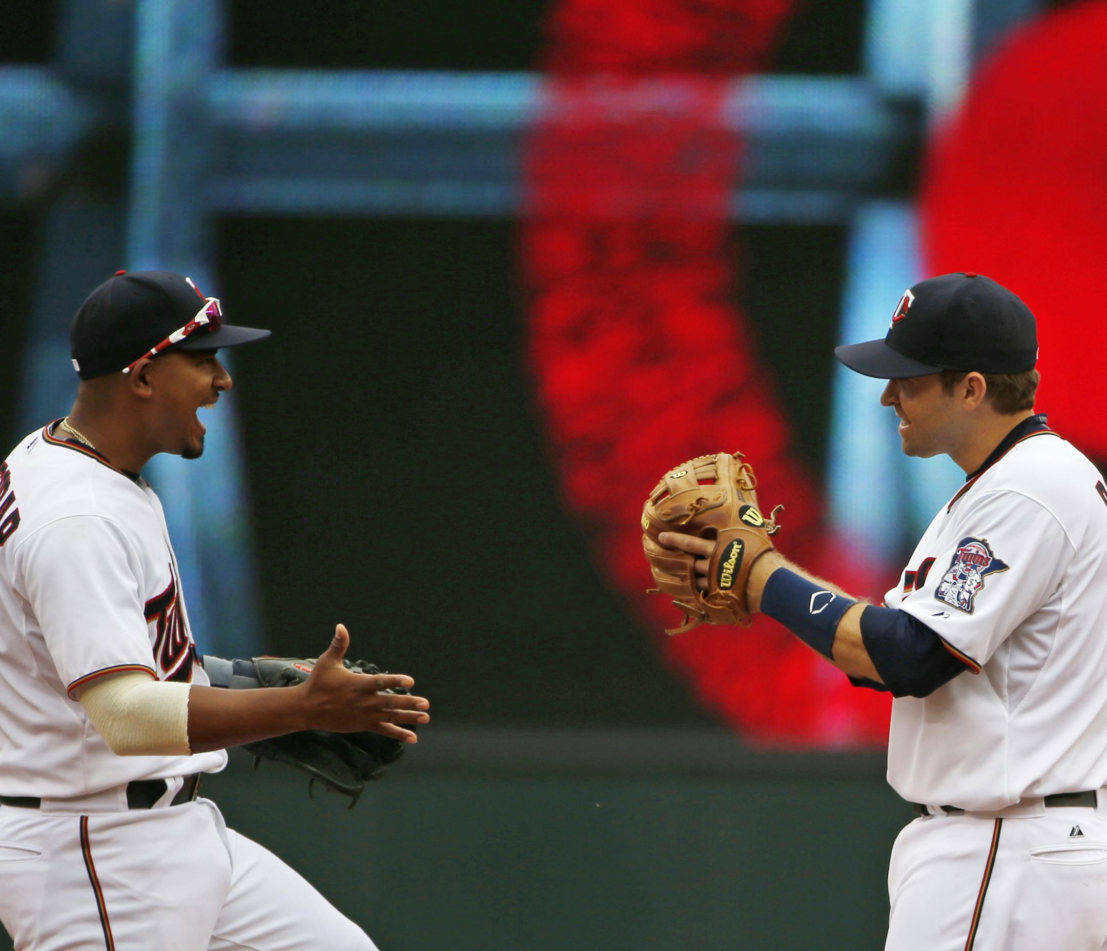 At Target Field in a game between the Indians and the Twins on April 9th, Eduardo Escobar(5) and Brian Dozier(2) celebrate the Twins' 7-2 win .] Richard Tsong-Taatarii/rtsong-taatarii@startribune.com