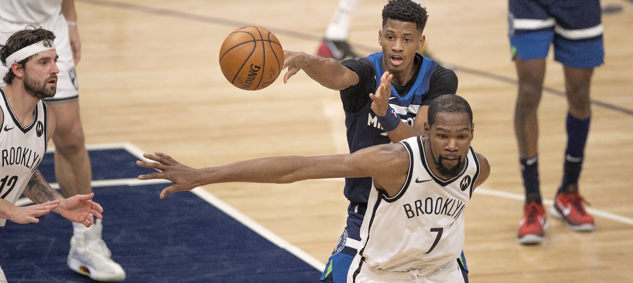 Minnesota Timberwolves forward Jarrett Culver (23) passed the ball around the out stretched arms of Brooklyn Nets forward Kevin Durant (7) at Target Center April 13, 2021 in Minneapolis.