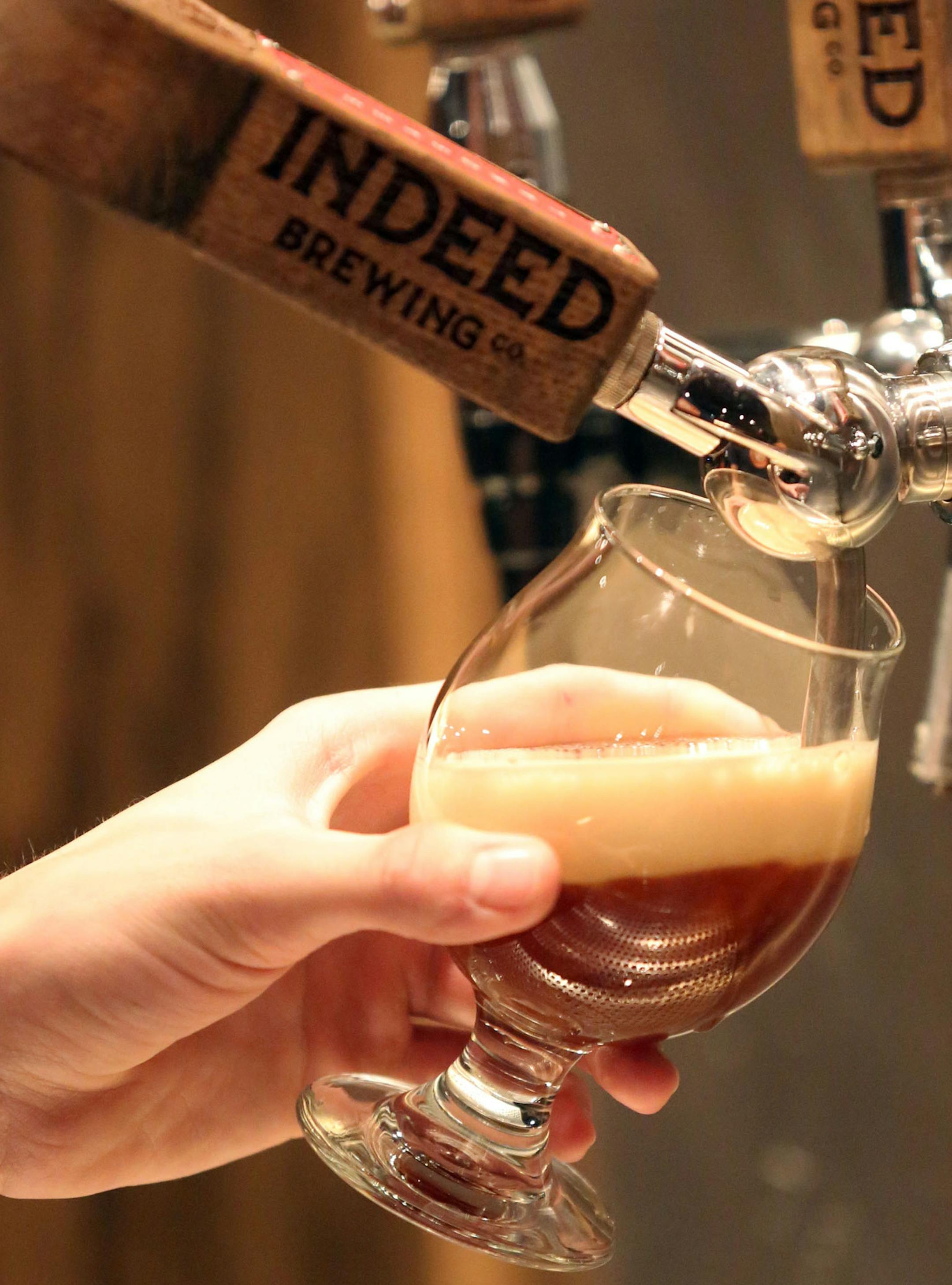 Old Friend holiday ale was poured for a a customer at the Indeed taproom in Minneapolis, Thursday, November 21, 2013. ] (KYNDELL HARKNESS/STAR TRIBUNE) kyndell.harkness@startribune.com