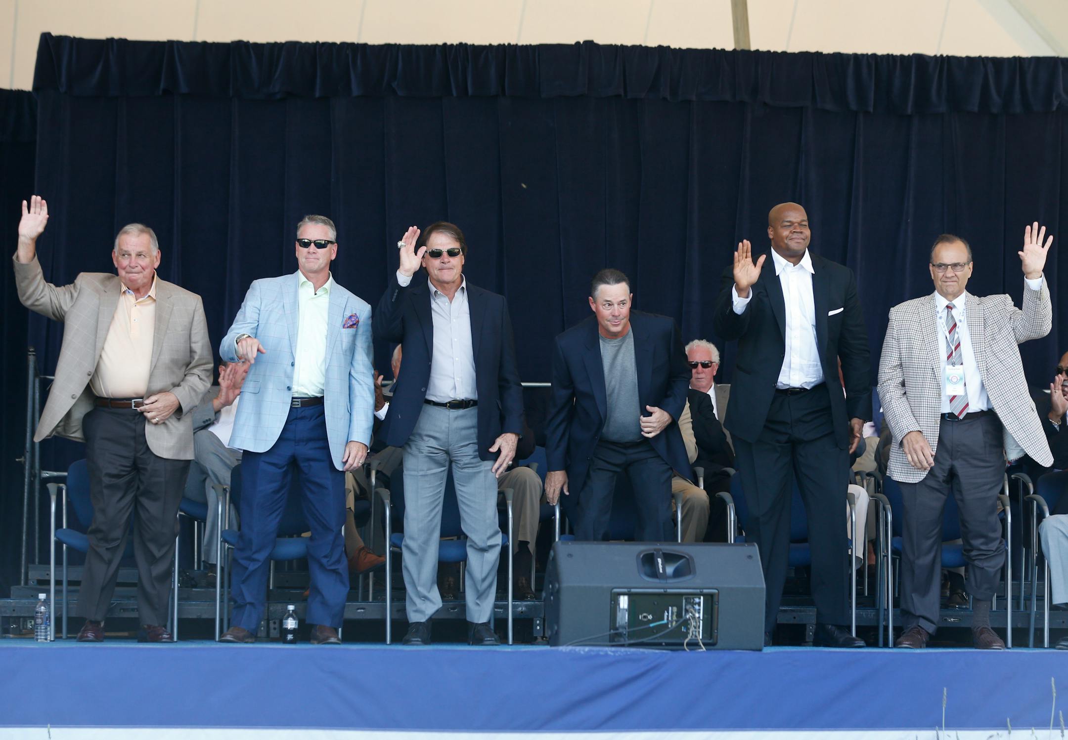 Baseball Hall of Fame electees Bobby Cox, Tom Glavine, Tony La Russa, Greg Maddux, Frank Thomas and Joe Torre are introduced during an awards ceremony at Doubleday Field on Saturday, July 26, 2014, in Cooperstown, N.Y. They will be inducted on Sunday. (AP Photo/Mike Groll)