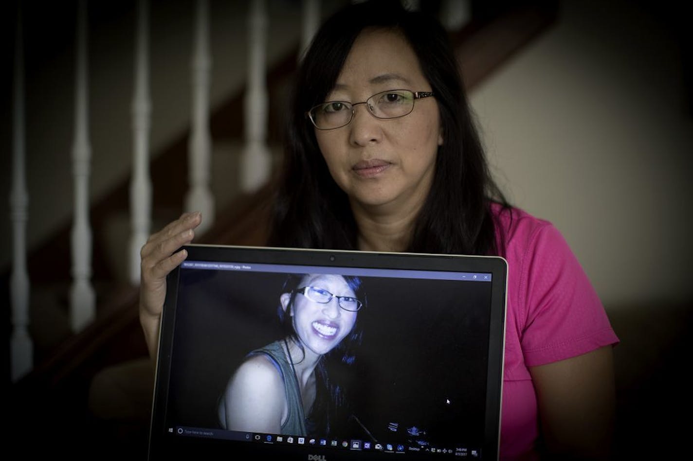 Still recovering from the death of her brother, who passed last year of cancer, May Seng Cha held a photo of her sister Mai Yer, at her home, Thursday, August 3, 2017 in St. Paul, MN. Mai Yer was a single mother and youngest of 9 kids. Mai Yer was stabbed as she tried to protect a friend at a Minneapolis ramp. "She was a very, very kind person who would help you whenever you need," her sister said.