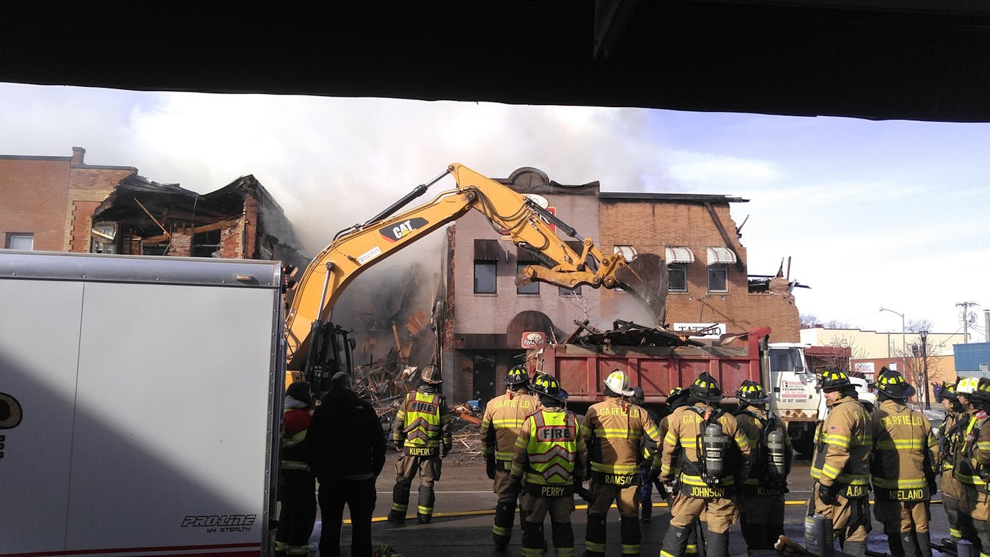 Firefighters in Alexandria pulled down burning buildings to keep a major downtown fire from spreading. ORG XMIT: -3XMQAXhD4HyzSmDzGi8