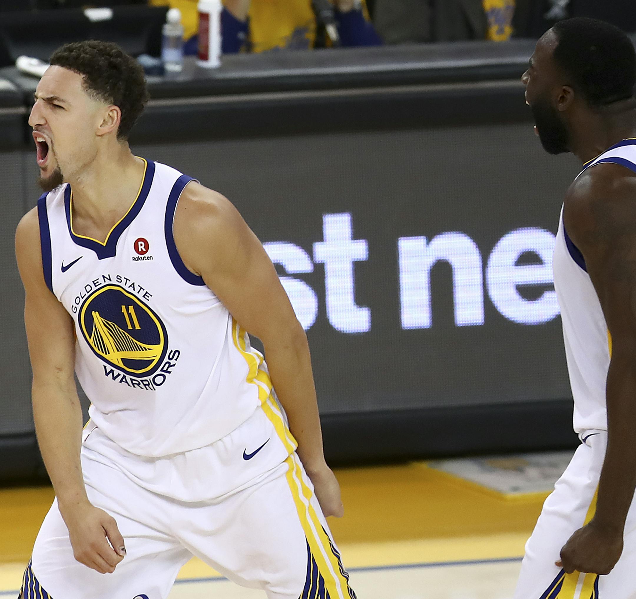 Golden State Warriors guard Klay Thompson (11) celebrates with forward Draymond Green during the second half of Game 6 of the NBA basketball Western Conference Finals against the Houston Rockets in Oakland, Calif., Saturday, May 26, 2018. (AP Photo/Ben Margot)