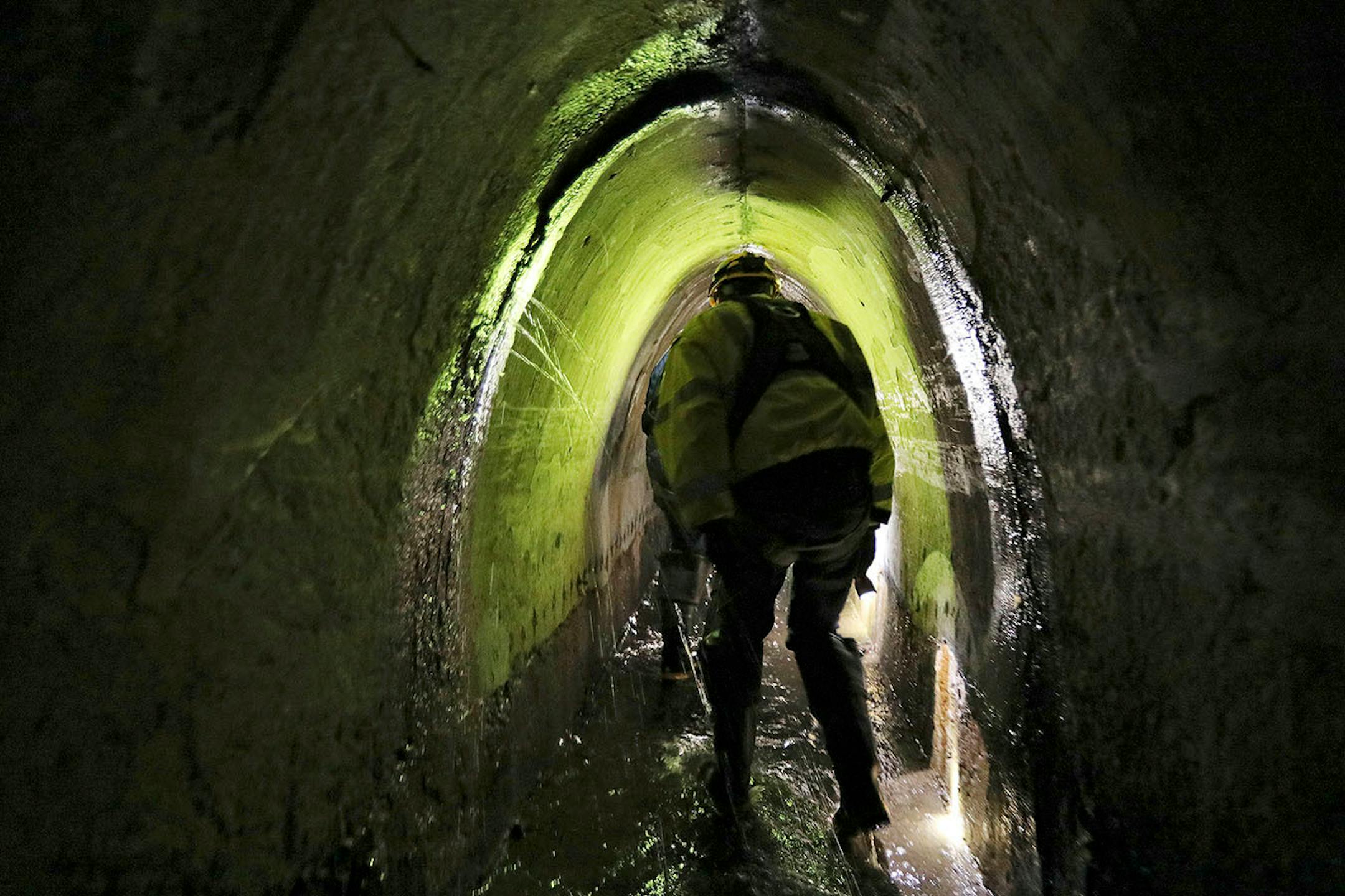 Officials with Minneapolis' Public Works Department, pointed out damage to part of the city's storm sewers in the northeast during a tour underground.