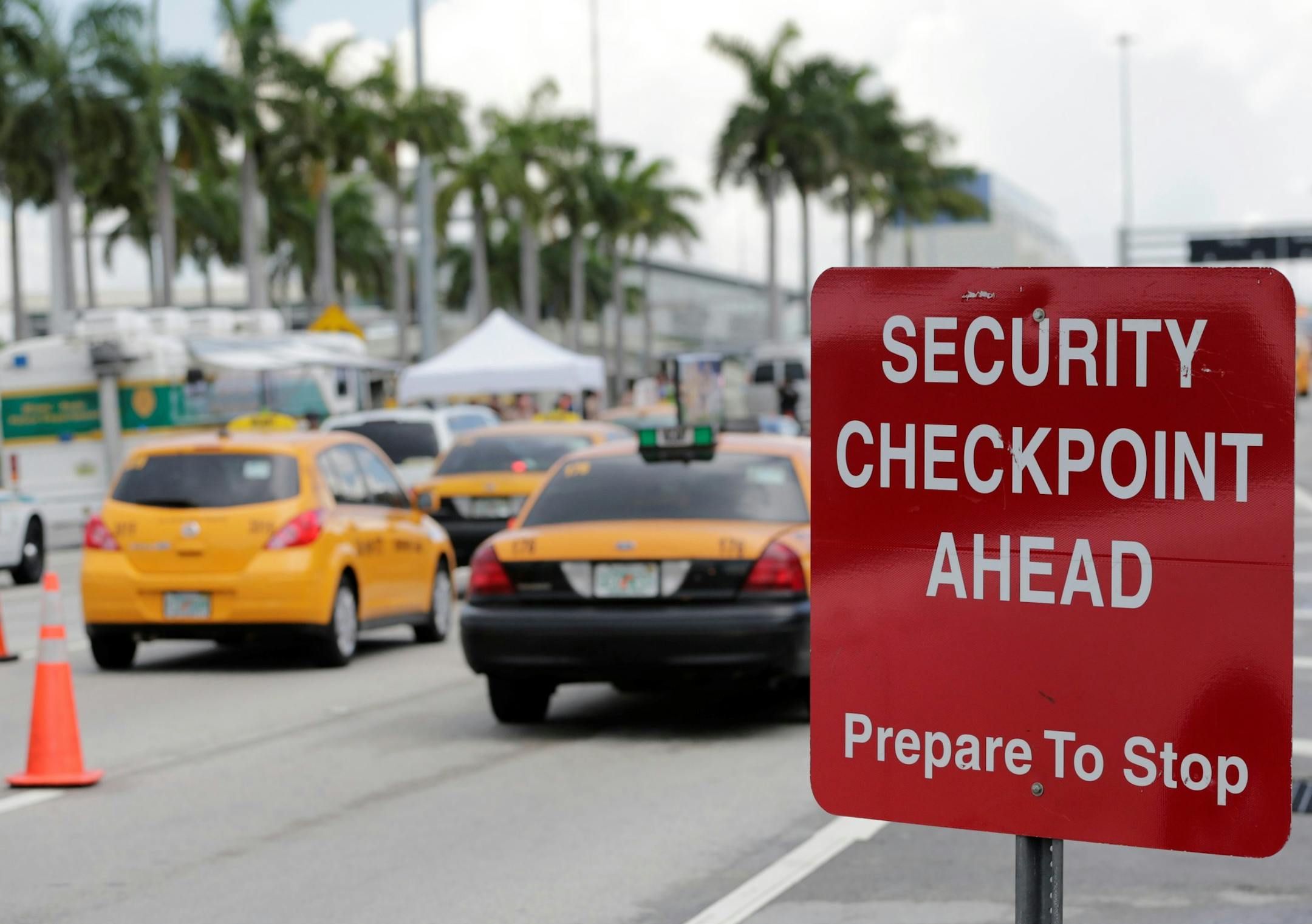 A sign is posted at a security checkpoint on a road leading to Miami International Airport, Friday, July 1, 2016, in Miami. There is increased security at the airport on this Independence Day holiday weekend after Tuesday's terrorist attacks at Istanbul's Ataturk International Airport. (AP Photo/Lynne Sladky) ORG XMIT: FLLS104