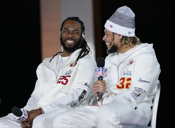 San Francisco 49ers' Richard Sherman, left, and Kansas City Chiefs' Tyrann Mathieu chat during Opening Night for the NFL Super Bowl 54 football game M