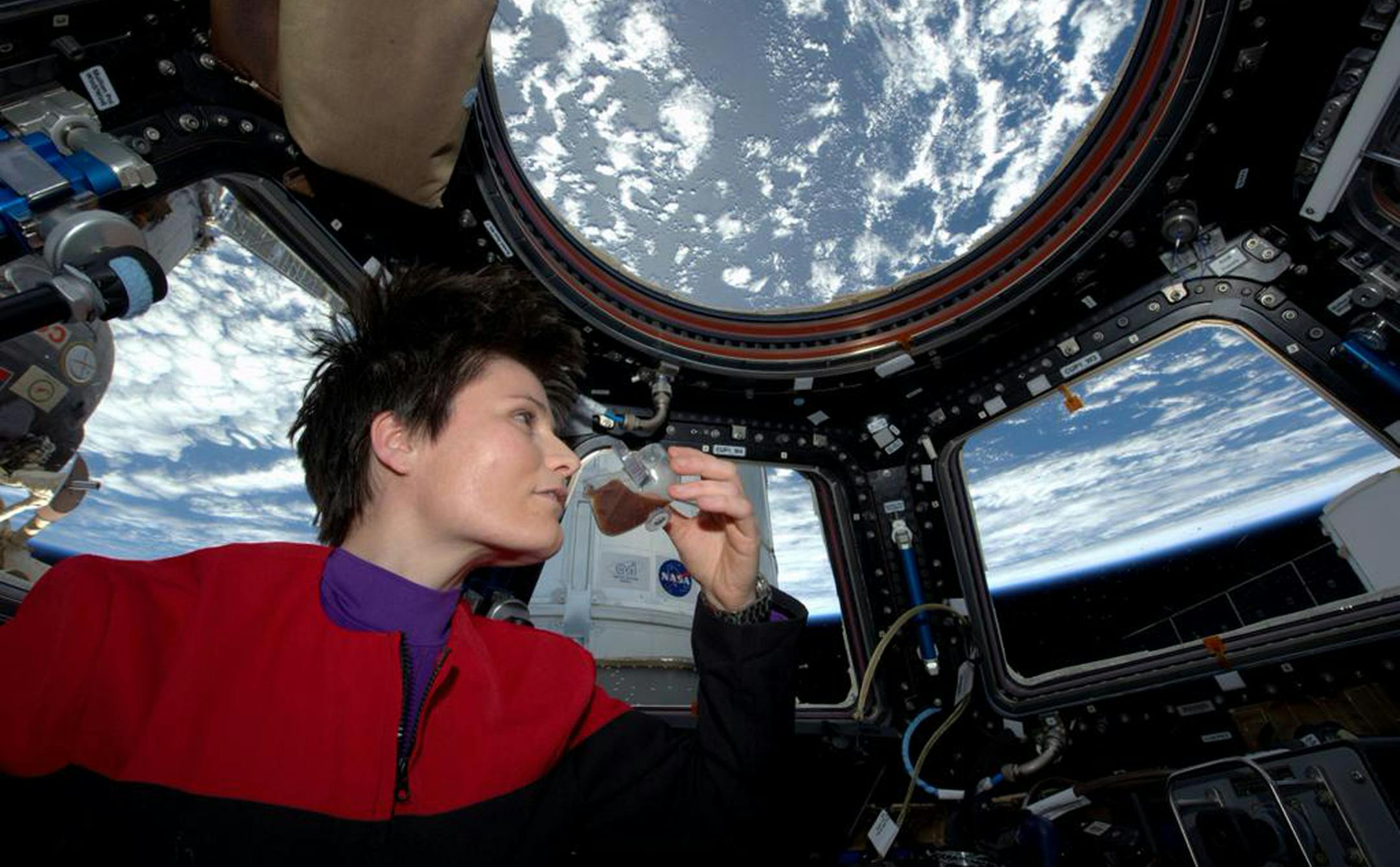 In this photo posted on Twitter, Sunday, May 3, 2015, and provided by NASA, Italian astronaut Samantha Cristoforetti sips espresso from a cup designed for use in zero-gravity, on the International Space Station. Cristoforetti, the first Italian woman in space, fired up the first espresso machine in space, which uses small capsules, or pods, of espresso coffee. (NASA via AP)