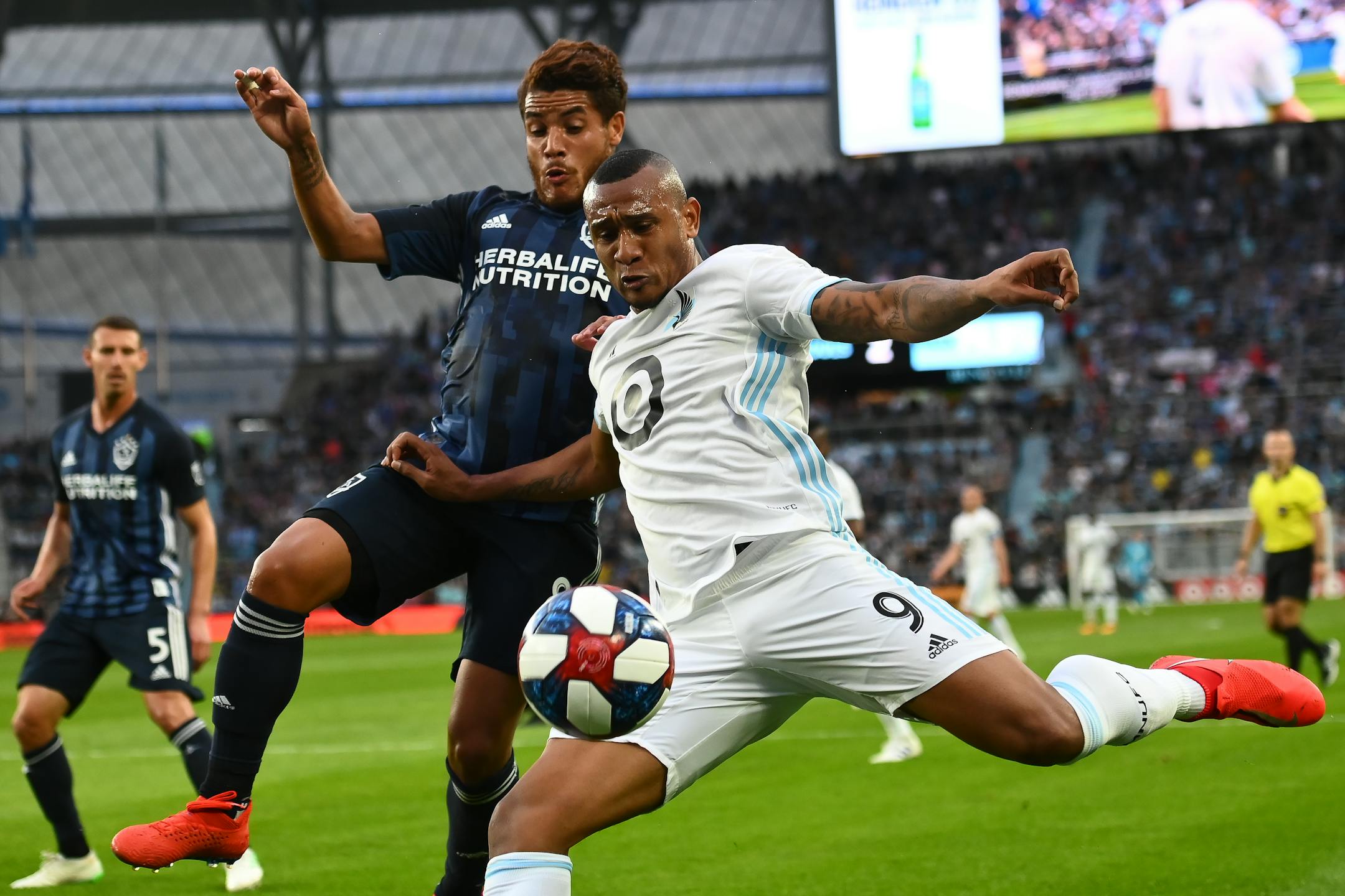 Minnesota United forward Angelo Rodriguez attempted a shot while being defended by Los Angeles Galaxy midfielder Jonathan dos Santos