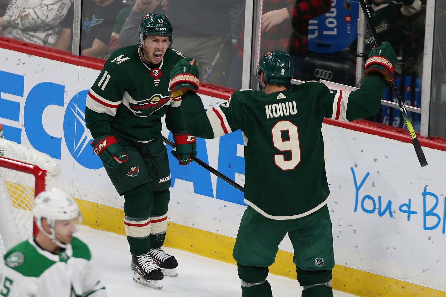 The Wild's Zach Parise celebrated with teammate Mikko Koivu after Parise's third-period goal against the Dallas Stars on Sunday.