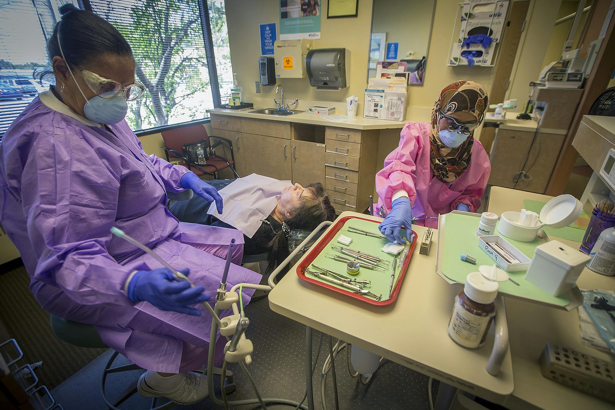 Dentist Dr. Sagal Nur, right, worked on a patient with dental assistant Rita Robinson at Open Cities Health Center, Thursday, July 27, 2017 in St. Paul, MN.