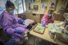 Dentist Dr. Sagal Nur, right, worked on a patient with dental assistant Rita Robinson at Open Cities Health Center, Thursday, July 27, 2017 in St. Pau