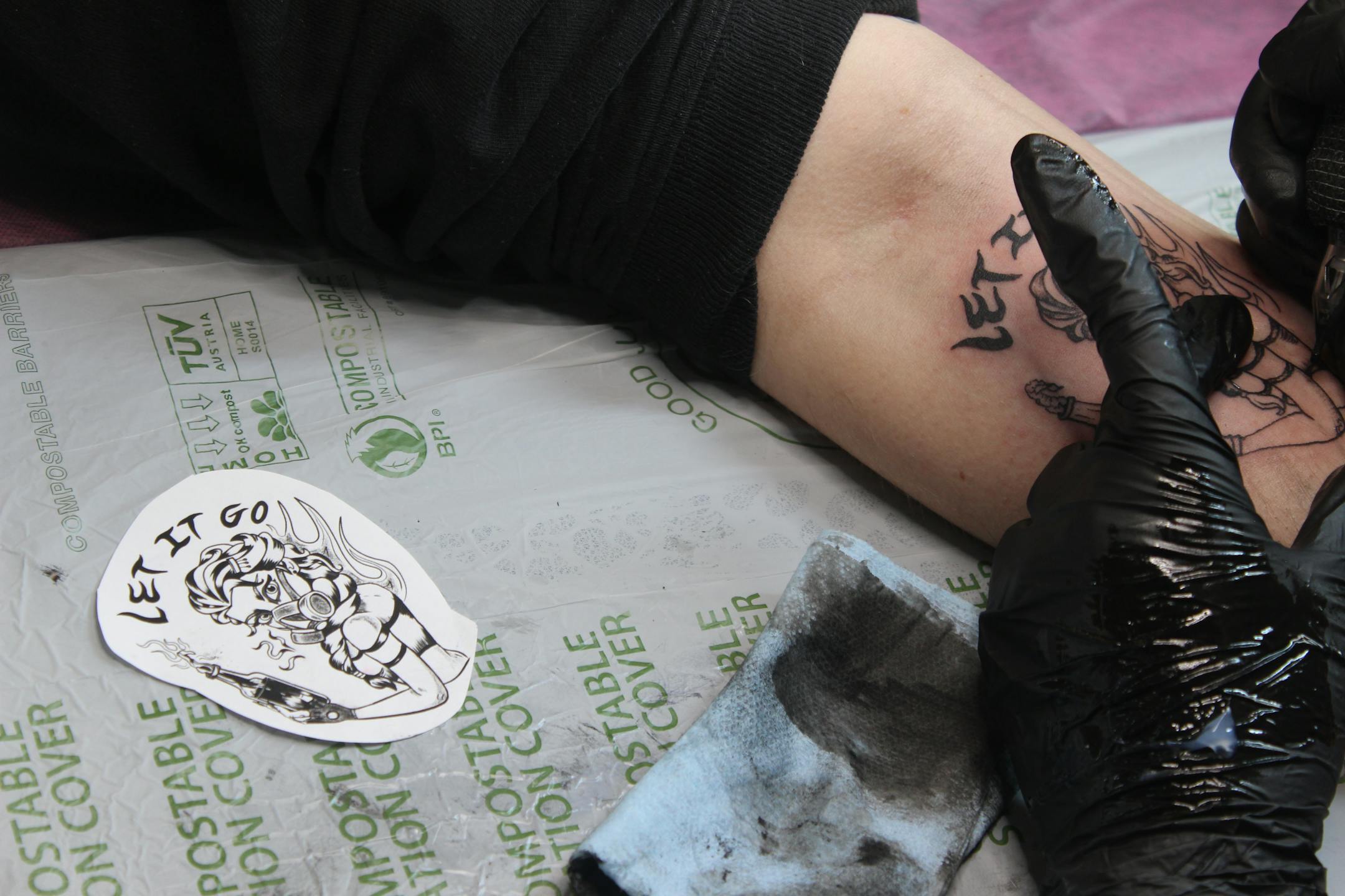 Bobby Wise's arm rests near the stencil design of a tattoo commemorating operation metro surge.