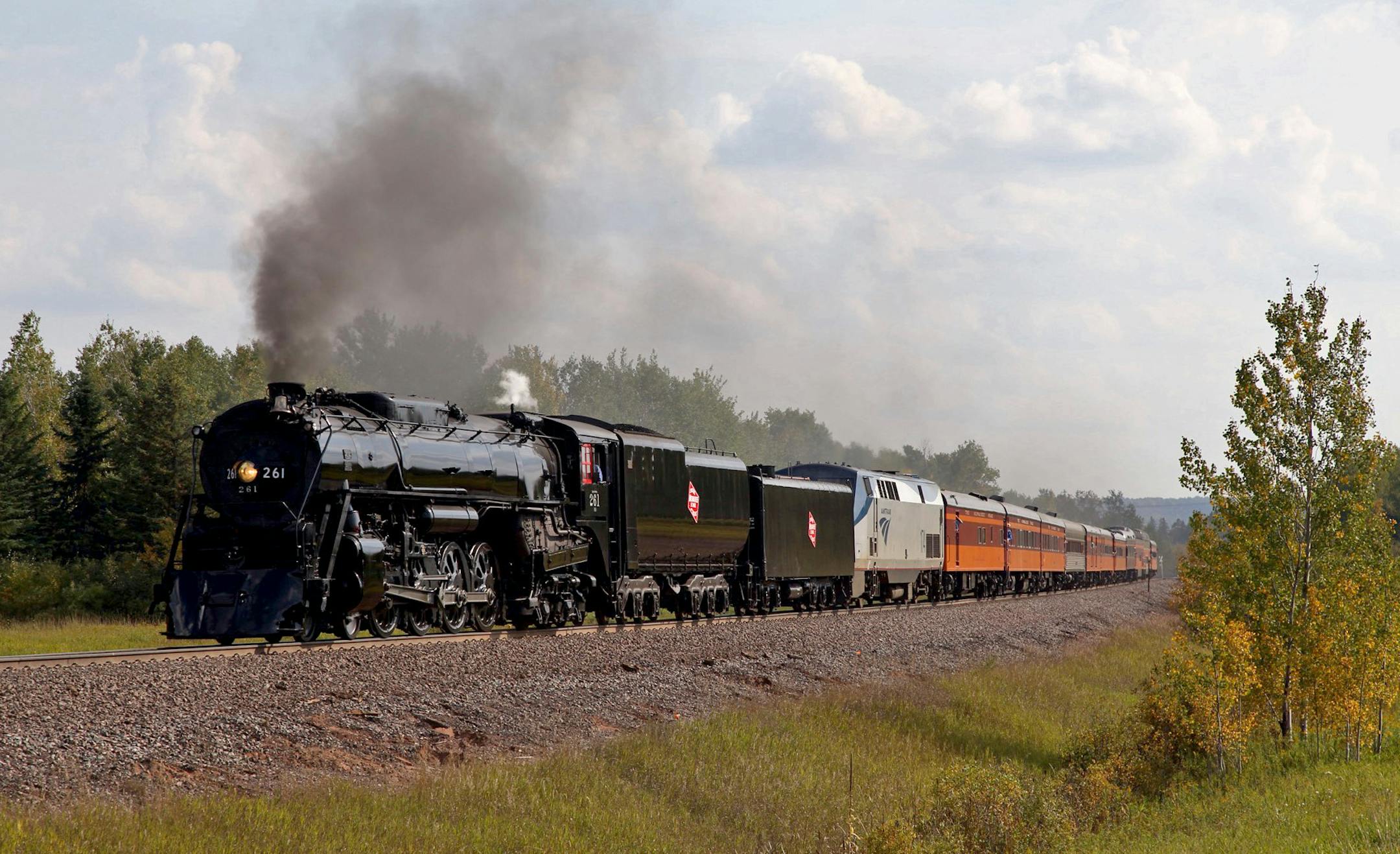 Courtesy of Jeff Terry. Caption: Milwaukee Road No. 261, a restored steam locomotive with a fleet of historic passenger cars, chugged to Duluth Saturday on a weekend excursion, one of several each year. It was a sentimental journey for many, including those grieving the loss of Judy Sandberg, who was instrumental in the nonprofit group called Friends of 261 Historic train makes trek honoring a woman who devoted many hours to its preservation.