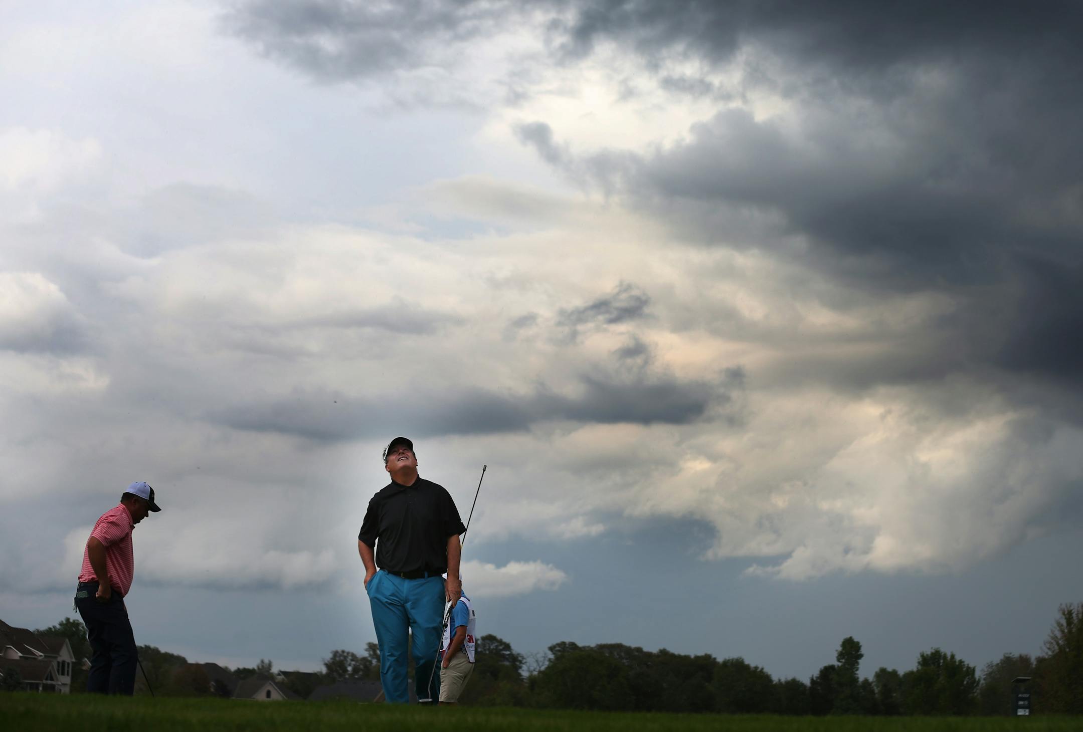 Paul Goydos looked up at the dark sky on the 16th green. He later went on to win the 3M Championship in a one-hole play off against Gene Sauers at TPC Twin Cities in Blaine on Sunday.