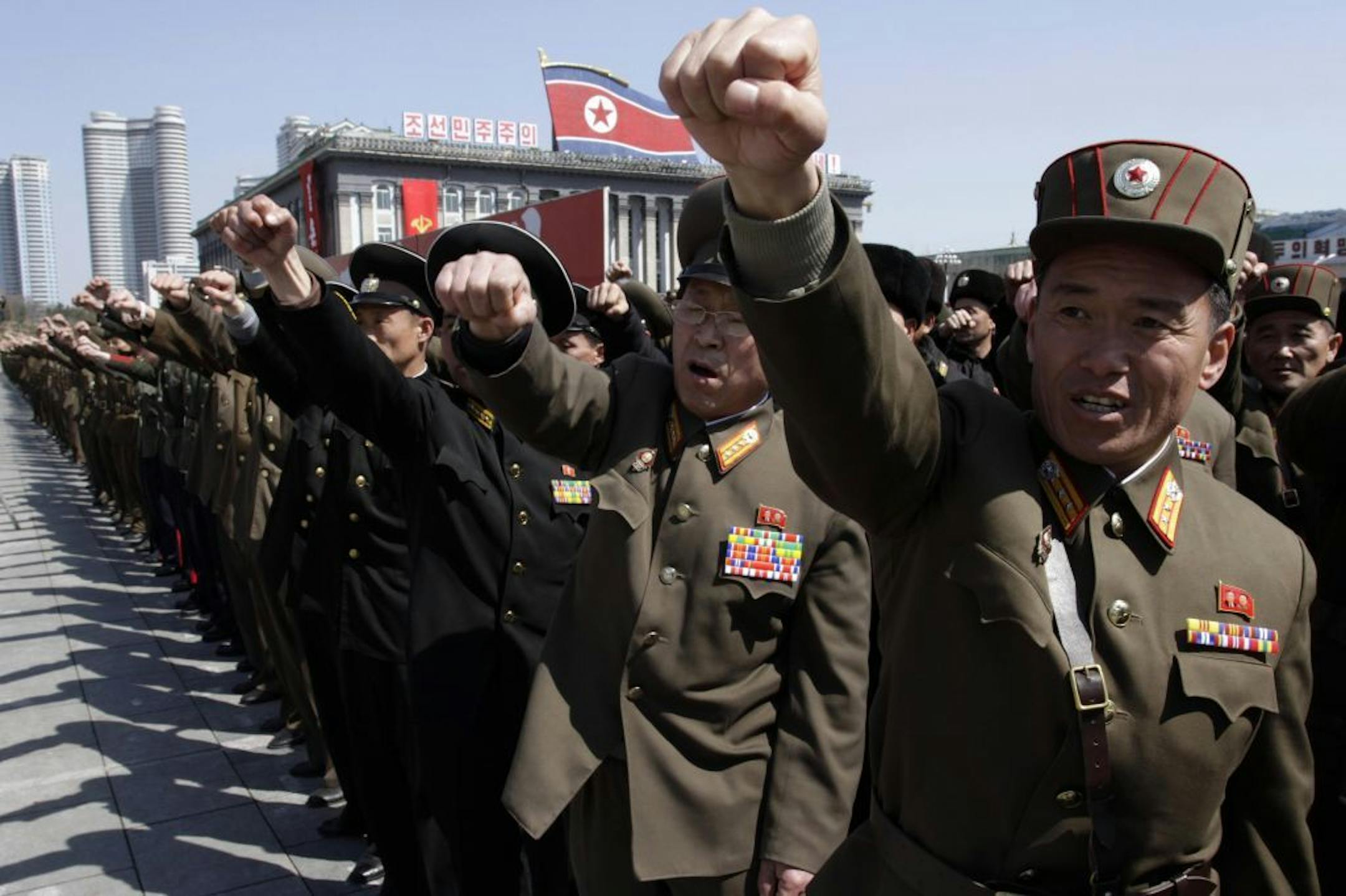 North Korean army officers punch the air as they chant slogans during a rally at Kim Il Sung Square in downtown Pyongyang, North Korea, Friday, March 29, 2013. Tens of thousands of North Koreans turned out for the mass rally at the main square in Pyongyang in support of their leader Kim Jong Un's call to arms.