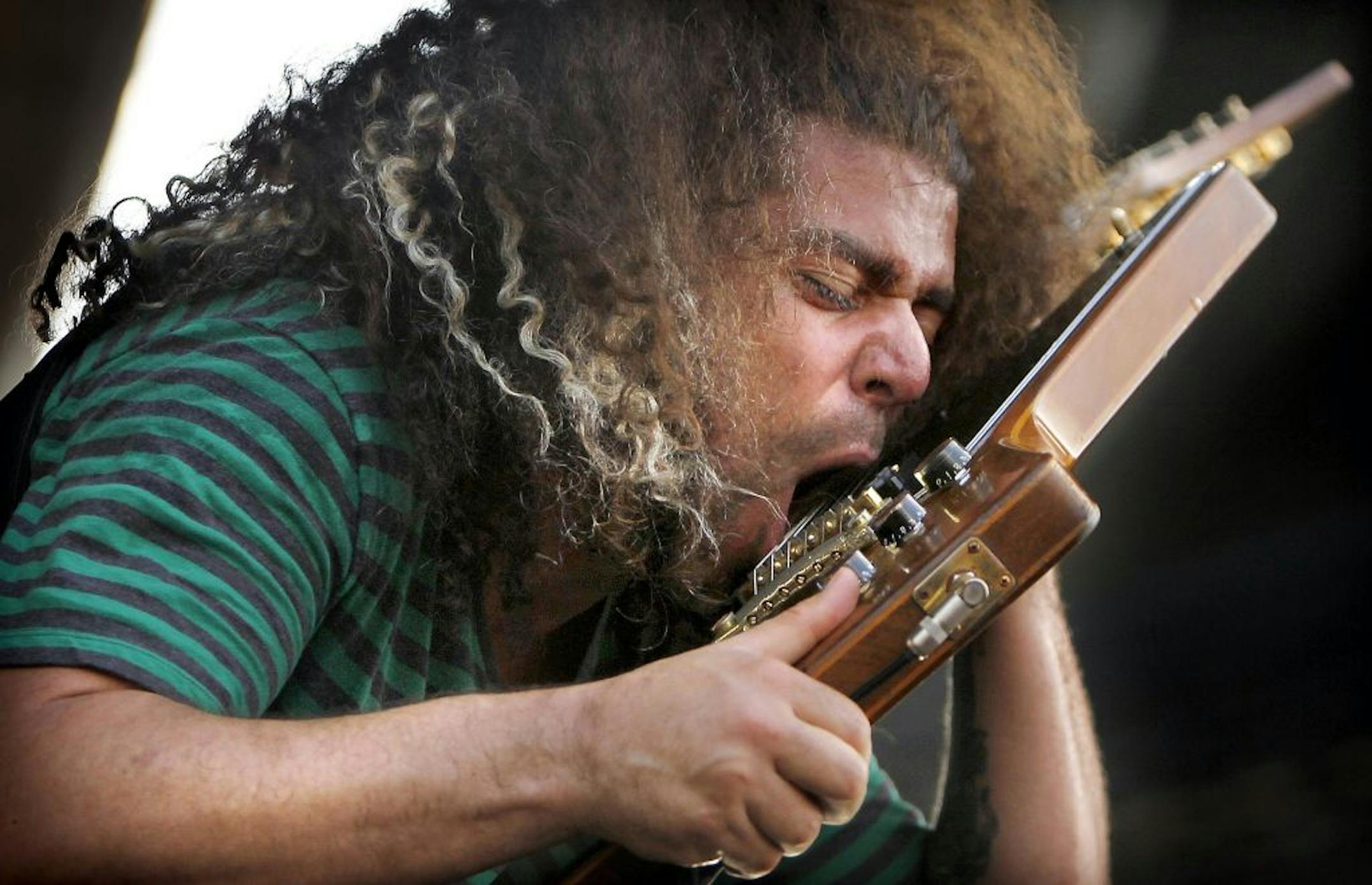 Claudio Sanchez, frontman for the rock band Coheed and Cambria, plays a few bars with his face during his performance at the Beale Street Music Festival Sunday, May 6, 2012 in Memphis, Tenn. The weather cooperated for a third straight day as crowds gathered to watch Coheed and Cambria and other acts like Bush, Herbie Hancock, and Wiz Khalifa.