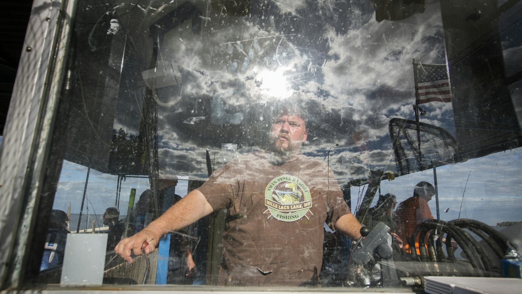 Captain Travis Koster steers the boat during an expedition run by Twin Pines Resort on Mille Lacs Lake Monday, August 3, 2015.
